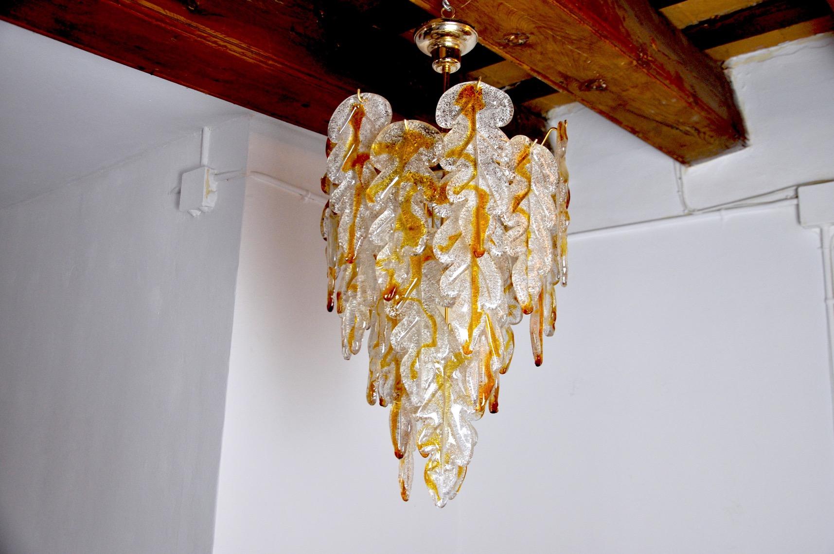 Superb and rare two-tone chandelier by Carlo Nason for Mazzega, designed and produced in Murano, Italy, in the 1970s. This chandelier is composed of more than 20 sheets of two-tone blown crystals and a brass structure. This chandelier is in a superb
