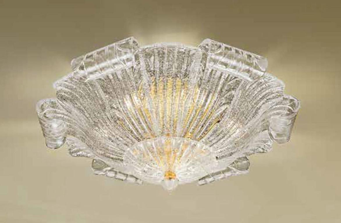 Italian flush mount with clear Murano glass leaves hand blown in Graniglia technique to produce granular textured effect, mounted on 24 K gold plated finish metal frame / Made in Italy in the style of Barovier e Toso
6 lights / E12 or E14 type / max