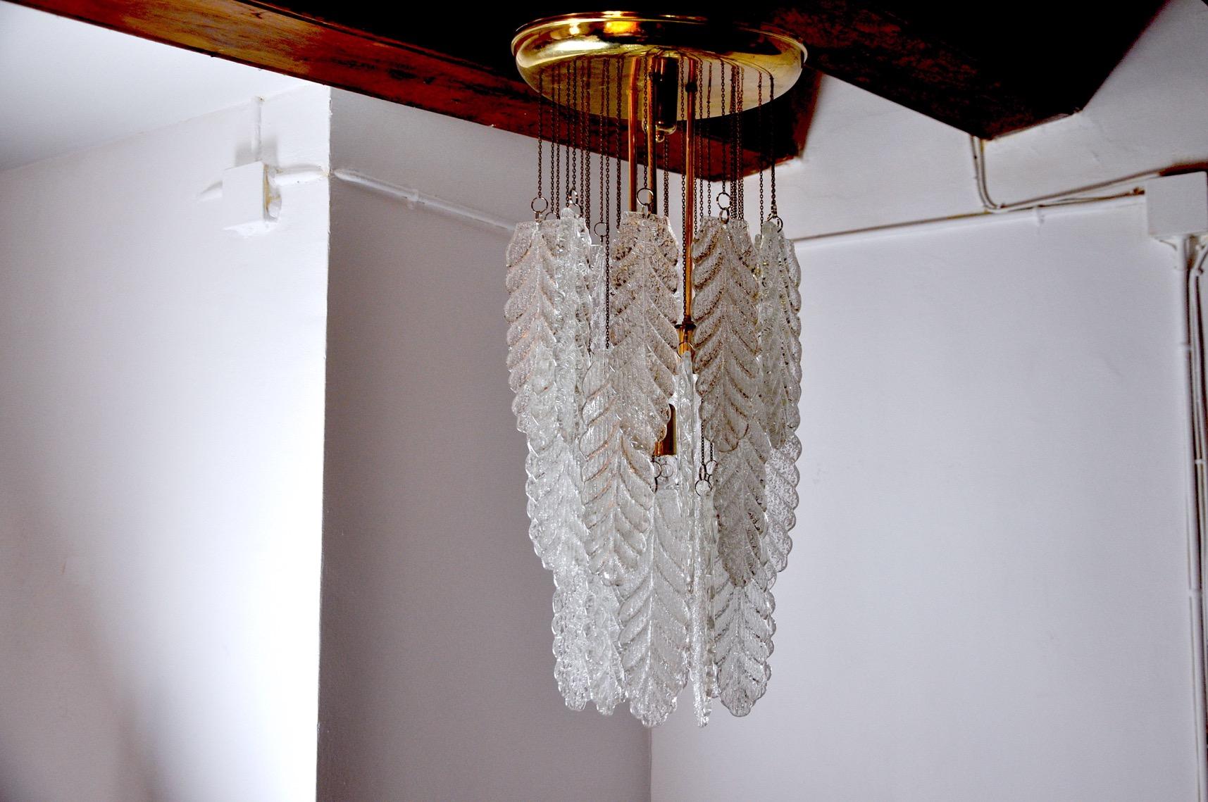 Superb and rare Mazzega pendant lamp designed and produced in Murano, Italy in the 70s. This magnificent chandelier is composed of long sheets of white frosted Murano glass, suspended in a spiral from a gold metal structure. Rare design object that