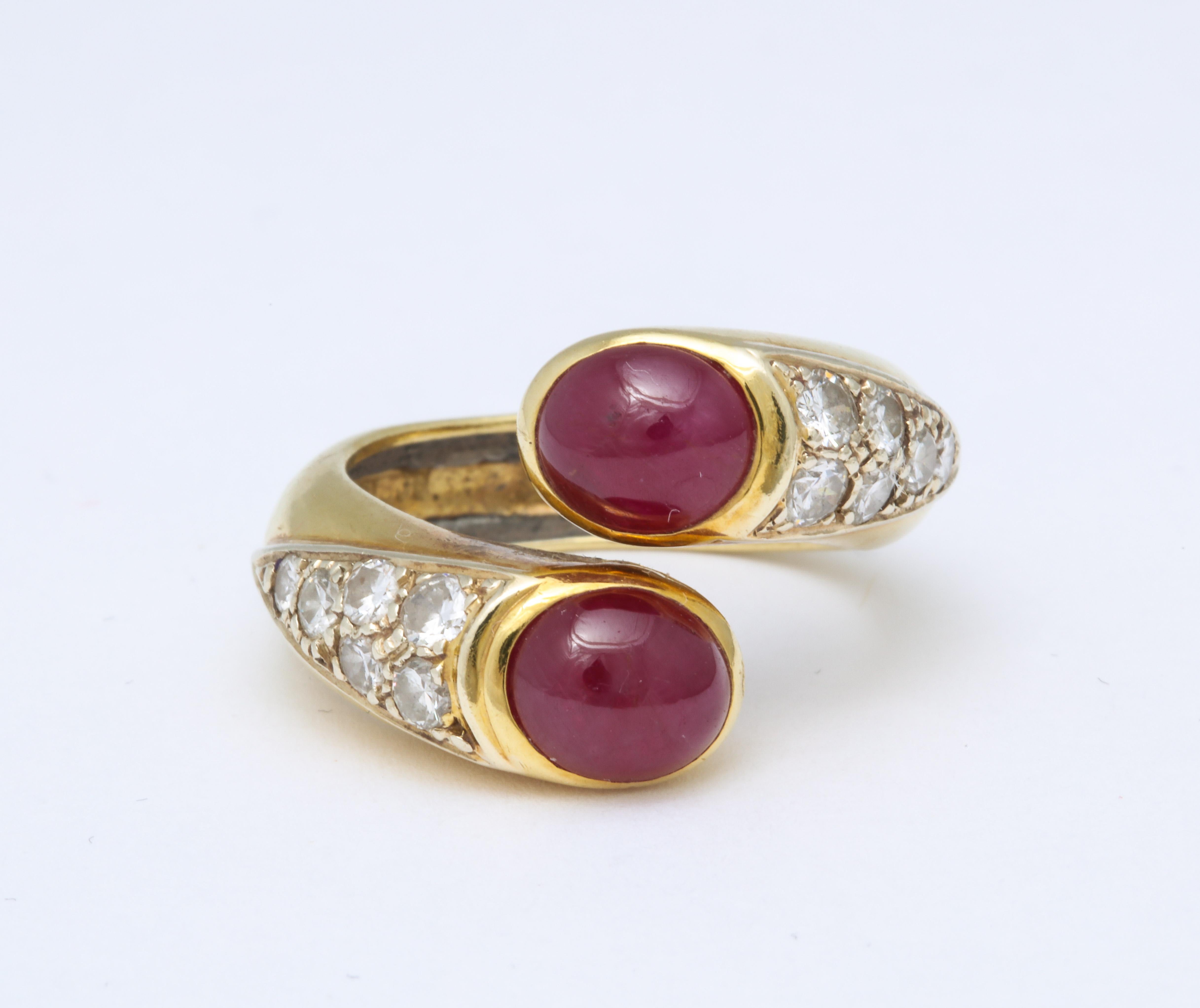 A fabulous Boris Lebeau Ruby and Diamond Gold Ring. A pair of untreated cabochon rubies meet with a tail of mine diamonds set on an 18 kt gold ring. Size 5 but can be adjusted to fit.  Signed 