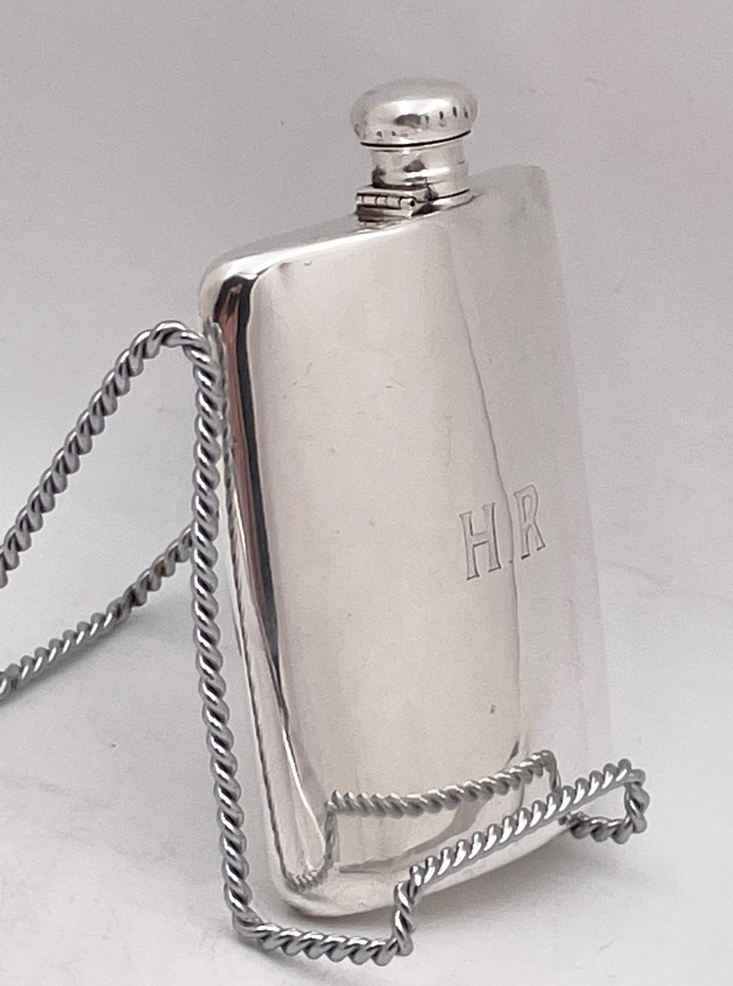 Lebkuecher sterling silver flask from the early 20th century in Art Deco style, with an elegant, geometric design. It measures 6 1/4'' in height by 4 3/4'' in width by 7/8'' in depth and bears hallmarks as shown. 

Lebkuecher was a Newark-based