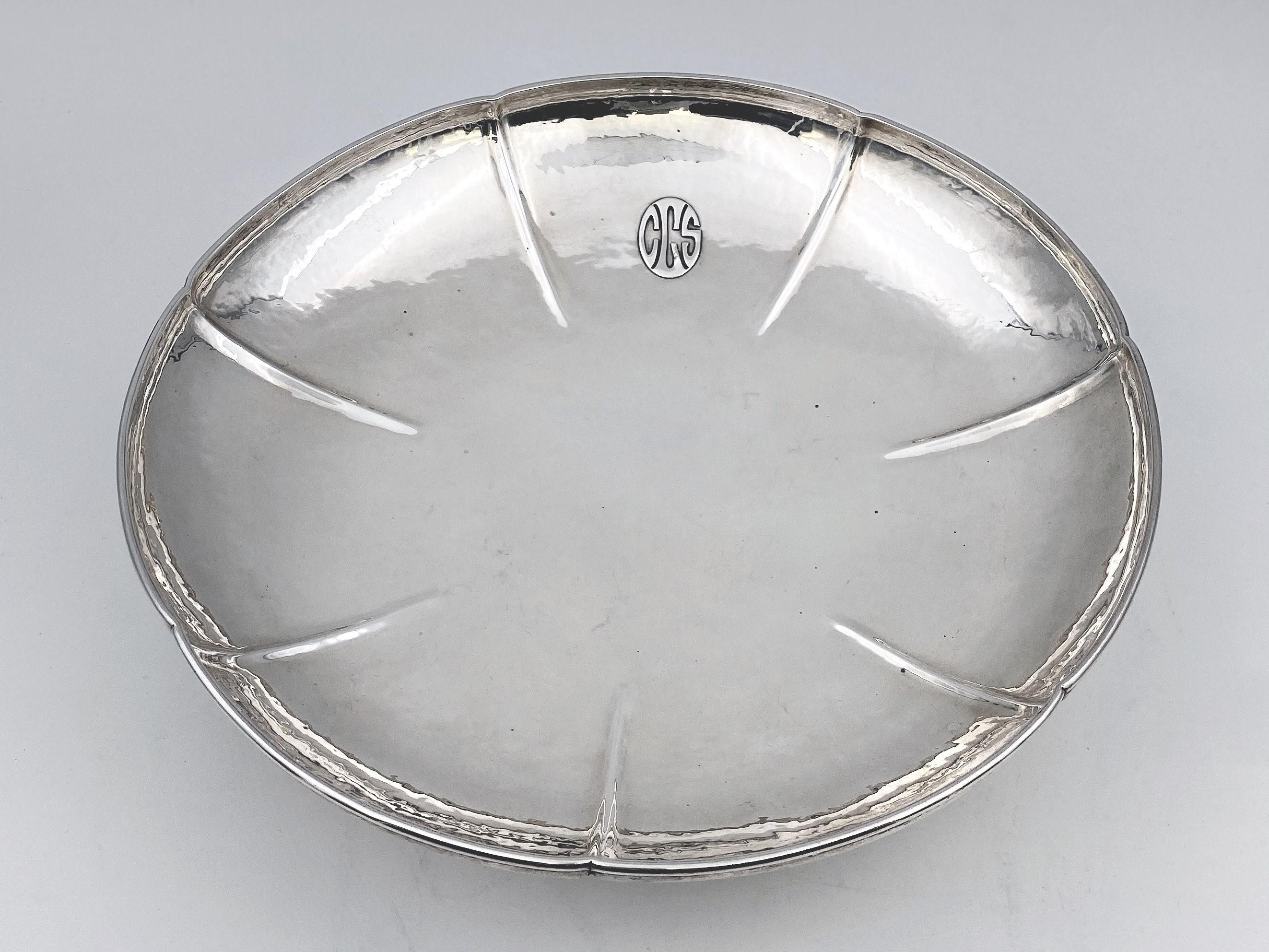 Lebolt & Co. sterling silver, hand beaten compote bowl on long stem flaring to circular foot. The compote has an applied engraving inside of the bowl in Arts & Crafts style, measuring 3 1/4 inches in height and 12 inches in diameter. The weight is