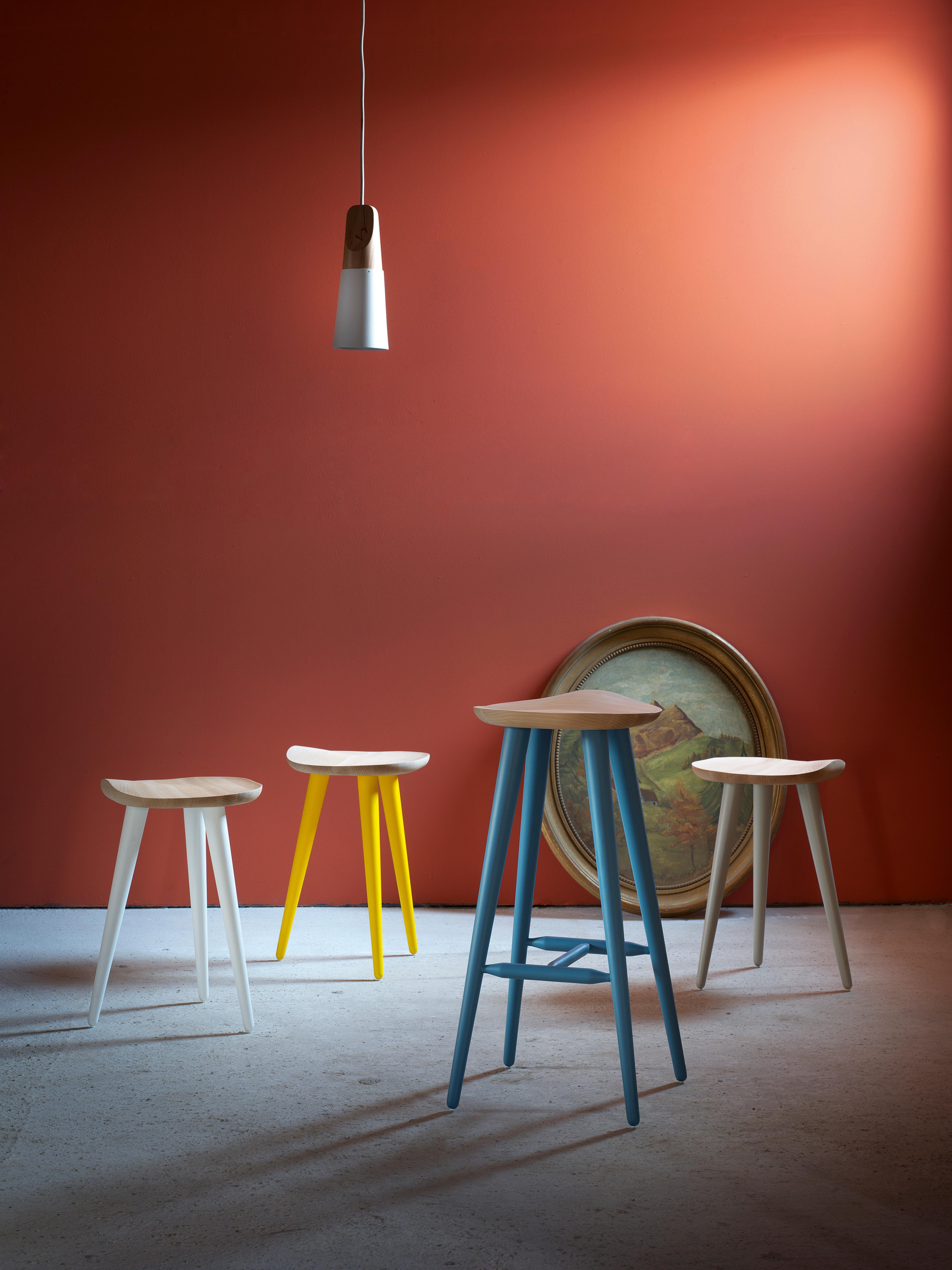 The thin but strong colored legs hold up a seat made of oiled beech with a comfortable shape of “bicycle saddle”. The stool is ideally suited to any environment.

Stool with beech legs lacquered. The seat is realised in oiled beech with a