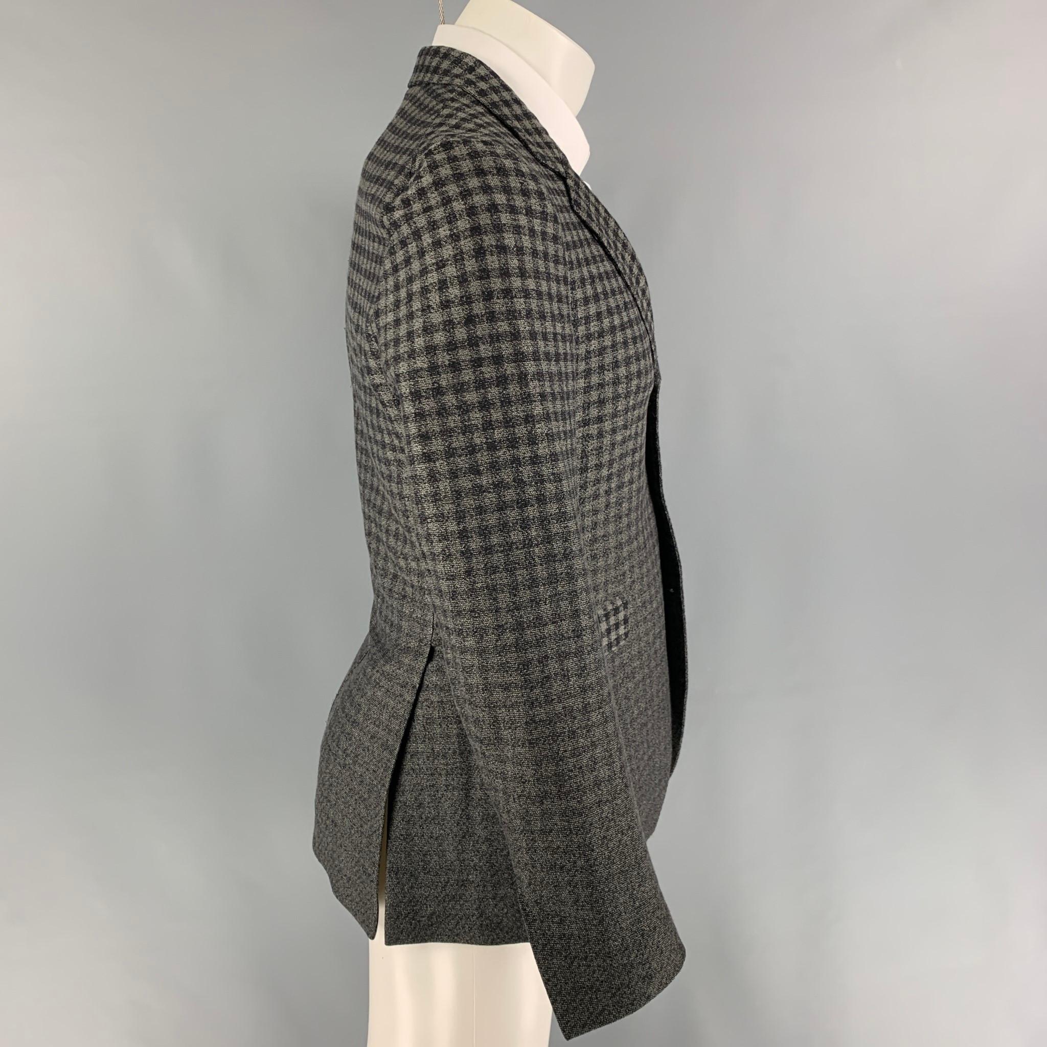 L'ECLAIREUR sport coat comes in a grey & black checkered cotton / wool with a half liner featuring a notch lapel, flap pockets, double back vent, and a three button closure. Made in Italy. 

Very Good Pre-Owned Condition.
Marked: