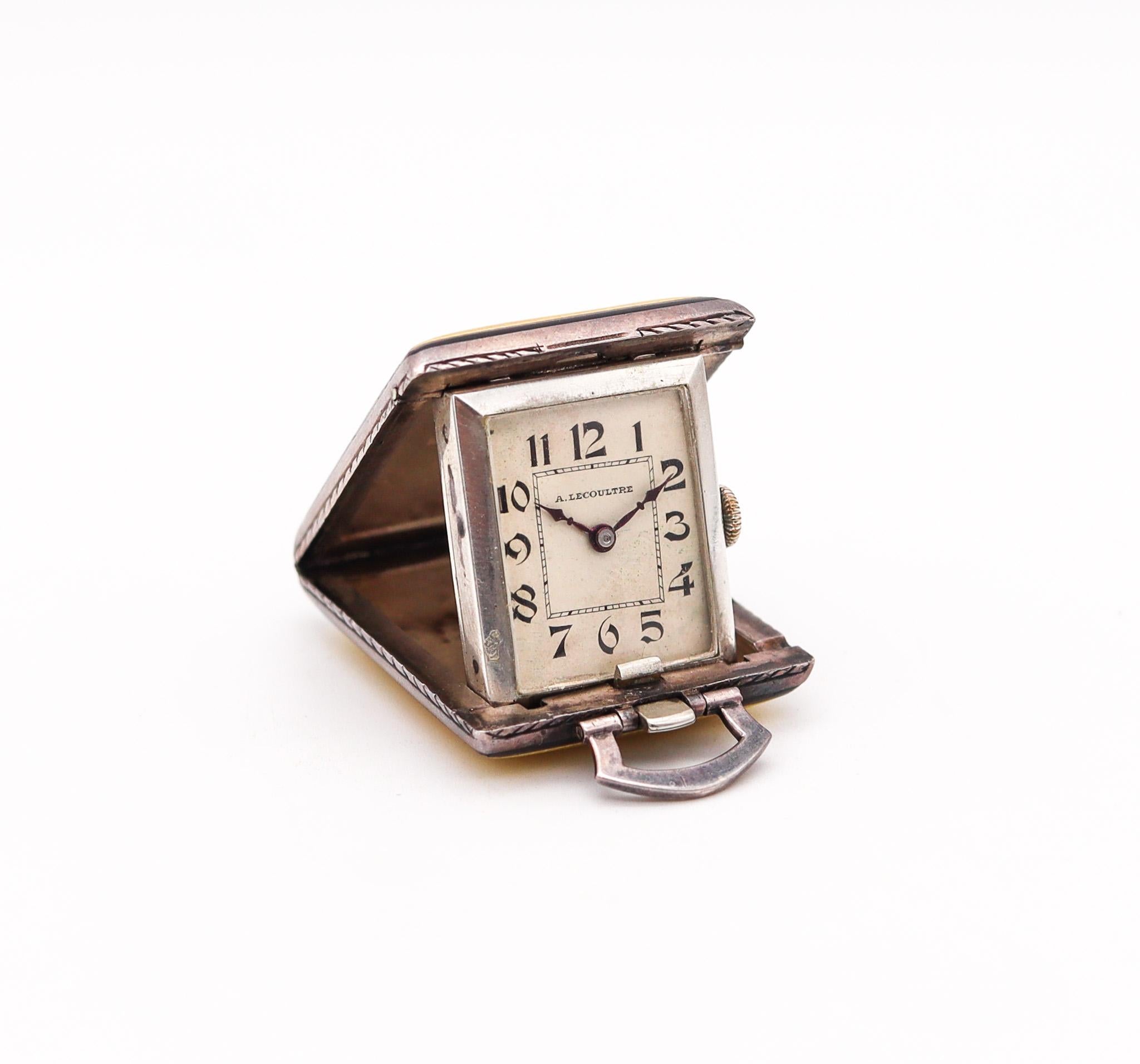 Travel and pendant clock designed by Antoine LeCoultre.

Beautiful foldable travel clock, manufactured in Switzerland by the company of Antoine LeCoultre back in the 1920. This exceptional clock can be fully displayed in a table or wear in a chain