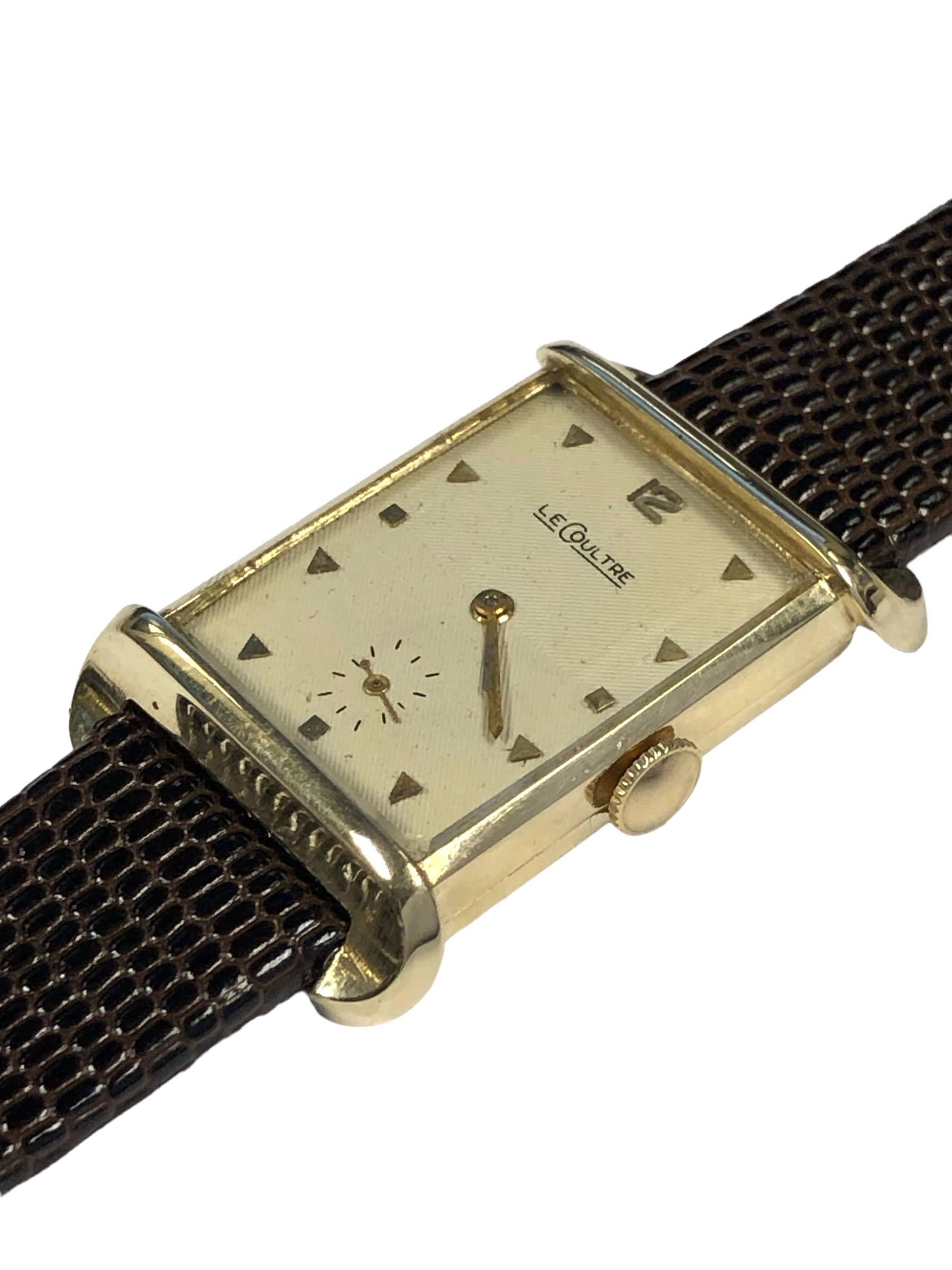 Circa 1950 LeCoultre Tank Wrist Watch, 29 x 21 M.M 2 piece 14k Yellow Gold case with Flared Lugs, 17 jewel, Caliber 438/4CW Nickle Lever, Mechanical, Manual wind movement, original Silver / White engraved striped, textured dial with raised Gold