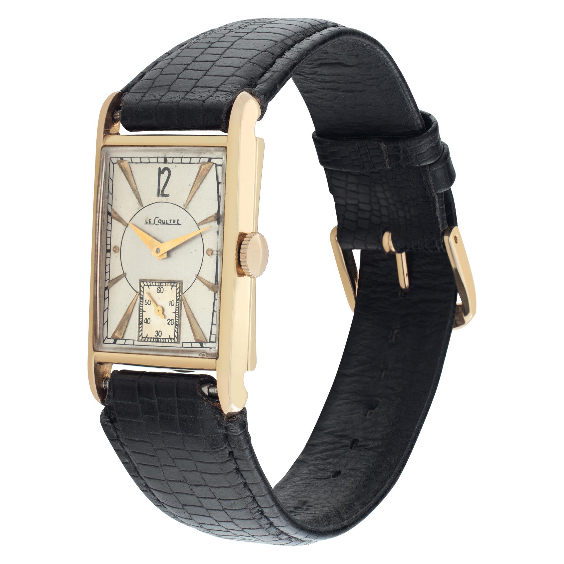 LeCoultre Classic in 14k on leather strap. Manual w/ subseconds. 20 mm x 27 mm case size. Fine Pre-owned LeCoultre Watch. Certified preowned Vintage LeCoultre Classic watch is made out of yellow gold on a Brown Leather strap with a tang buckle. This