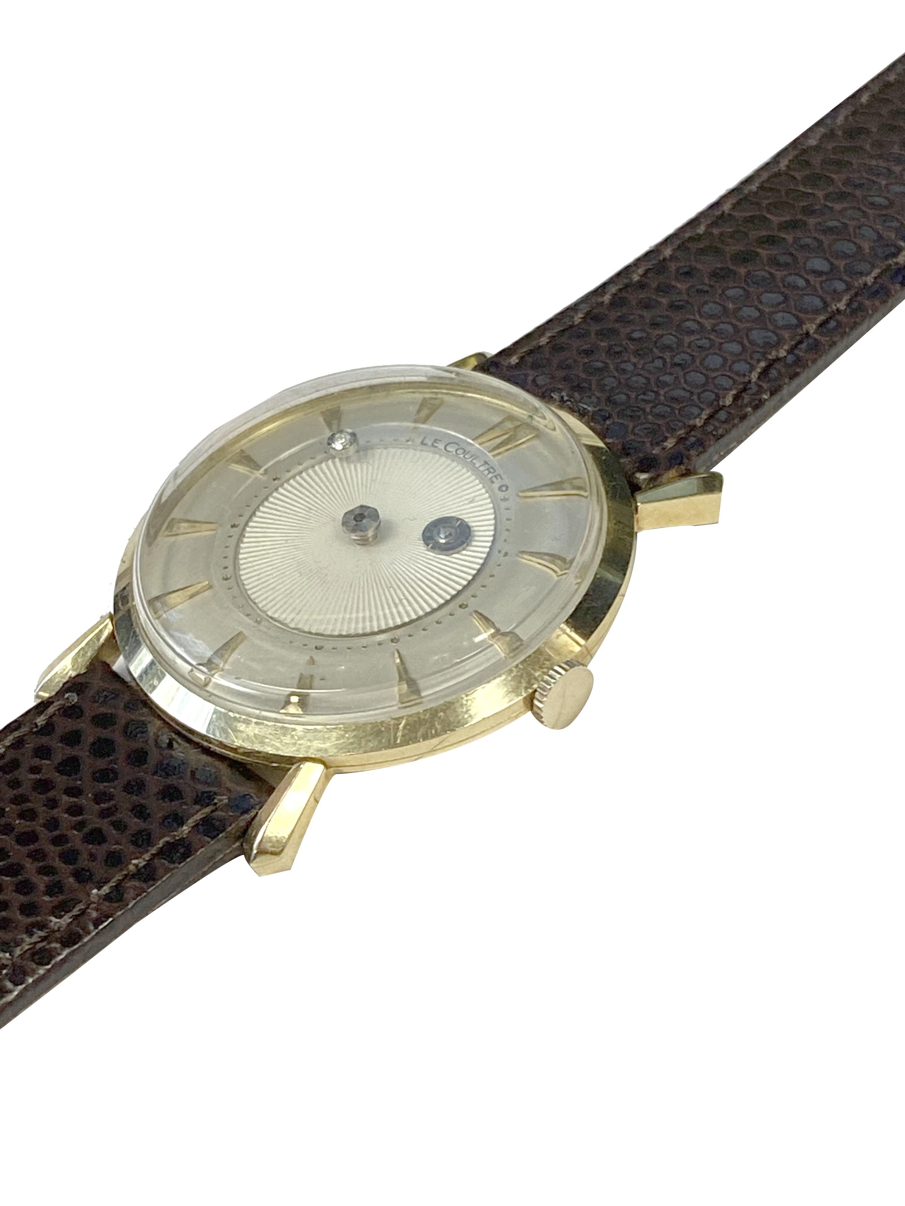 Circa 1950s LeCoultre Mystery Dial Wrist Watch, 32 M.M. 14k Yellow Gold 2 piece case with Flared Lugs, 17 Jewel Mechanical, Manual Wind movement. Excellent Original Silver Satin Dial with raised Gold markers, textured center and floating disk with