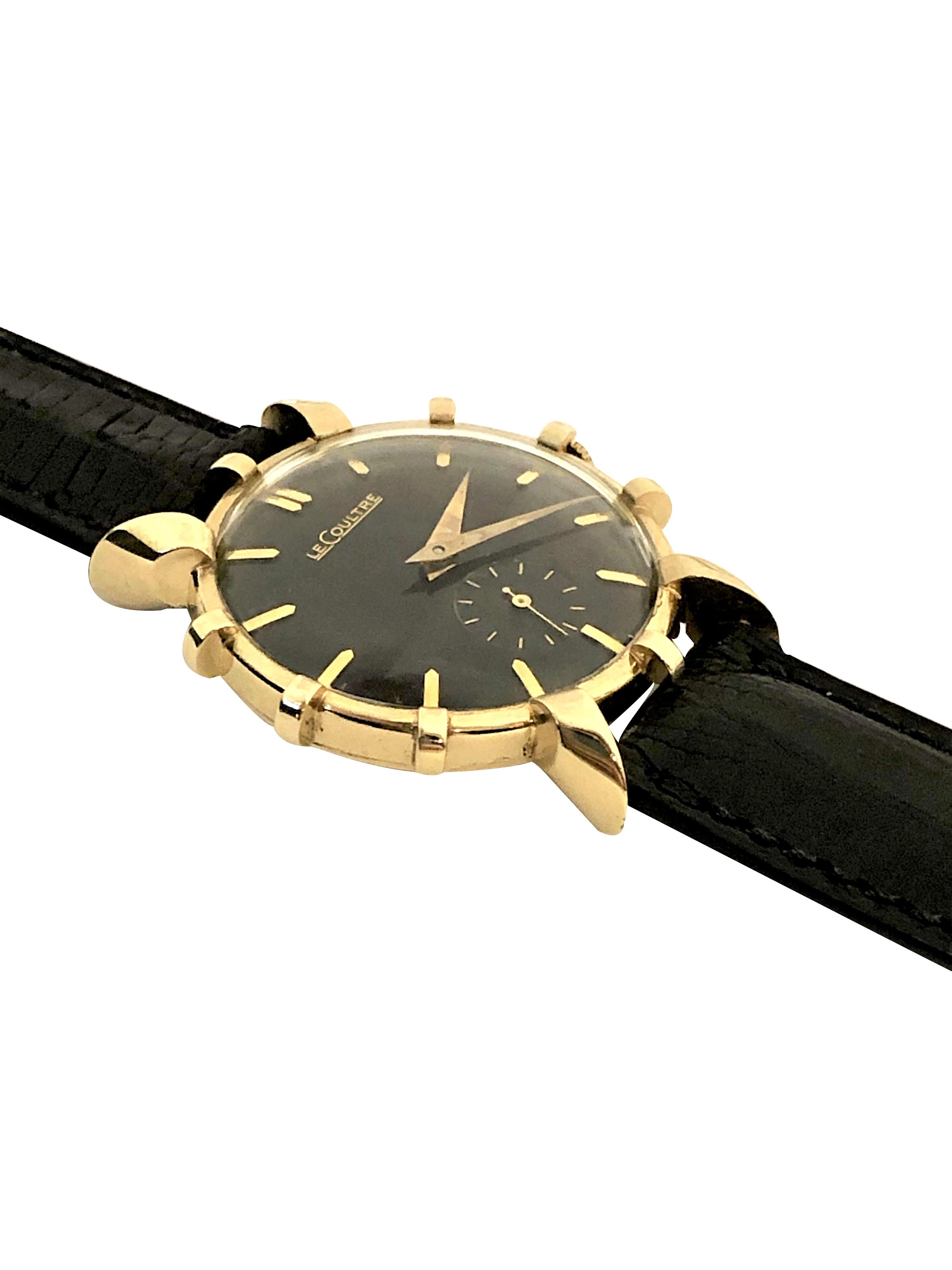 Circa 1950 LeCoultre Wrist watch, 32 M.M. 14K Yellow Gold 2 piece case with Flared Lugs and Flared case mountings. 17 Jewel Mechanical, Manual wind nickle lever movement. Black dial with raised gold markers, sub seconds chapter. New Black padded