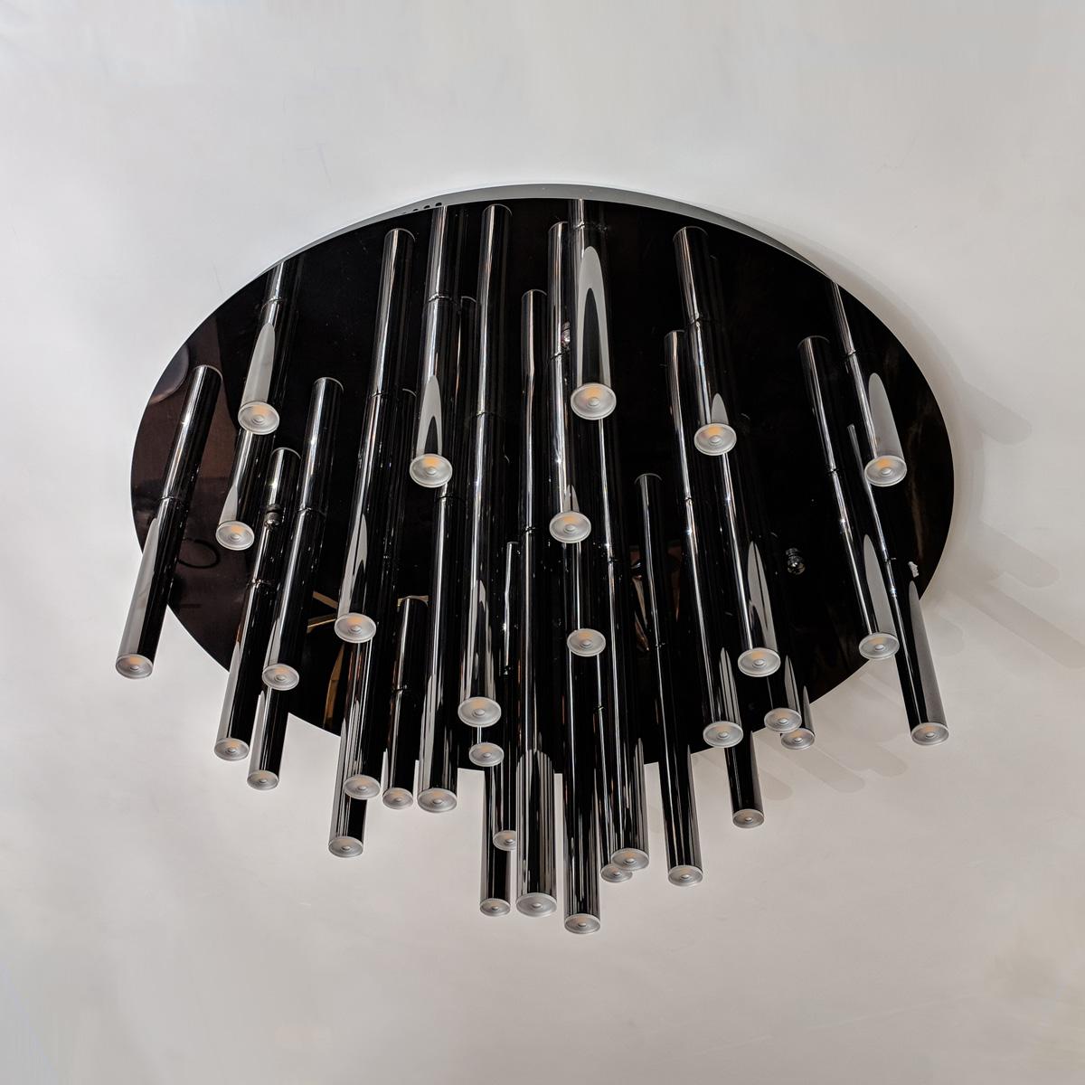 Tube LED lights grouped on a round ceiling plate.
Available in 3 standard sizes.
Can be customized to your specifications.

Dimensions: 
NO/CL/DRAPE/RD24: 24? dia. x 13?H / 33 x 1W LED Shown in polished black nickel finish
NO/CL/DRAPE/RD31:
