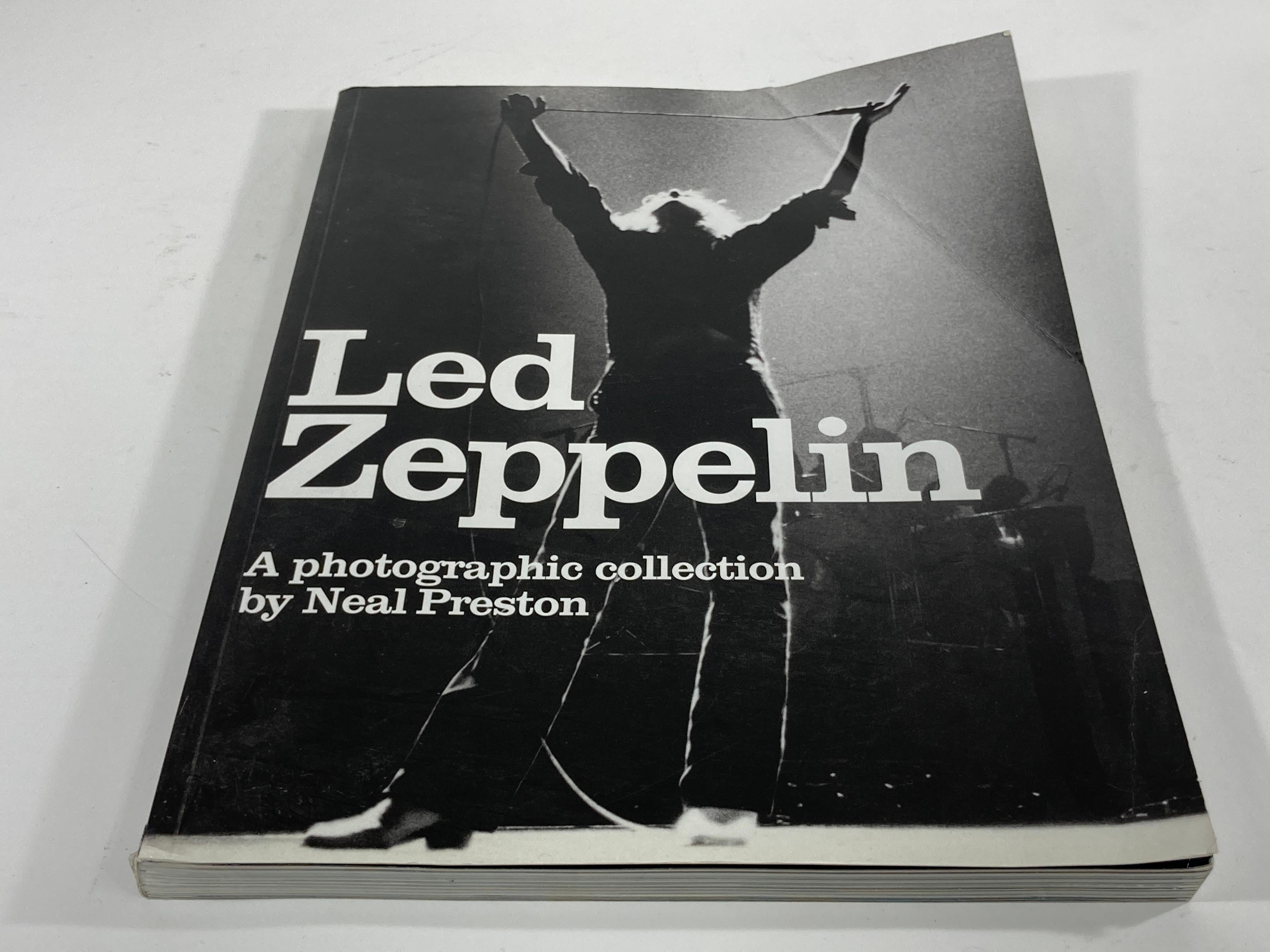 Led Zeppelin: A Photographic Collection Book by Neal Preston.
1st Edition: 2002, out of print.
Author: Neal Preston.
Softcover book.
192 page large photo history book of the legendary rock band Led Zeppelin.This is a huge soft cover