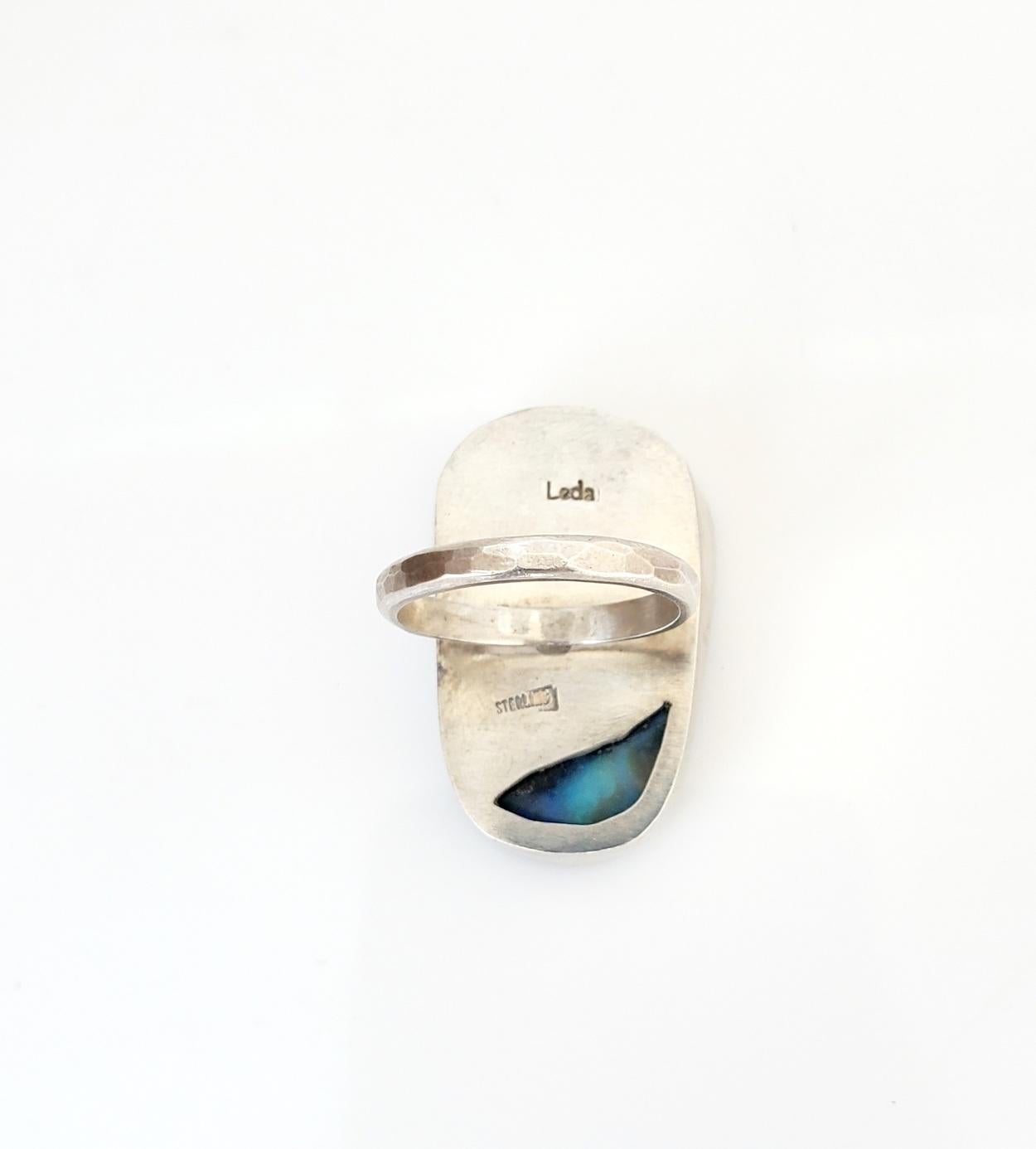  Large, one of a kind, Australian boulder opal ring. This opal measures about 38 X 18 mm. Hand set in a fine silver bezel, sterling silver back and band. Hammered band with a brush finish. Size 6.25. 
The Metaphysical Particulars: Opals offer