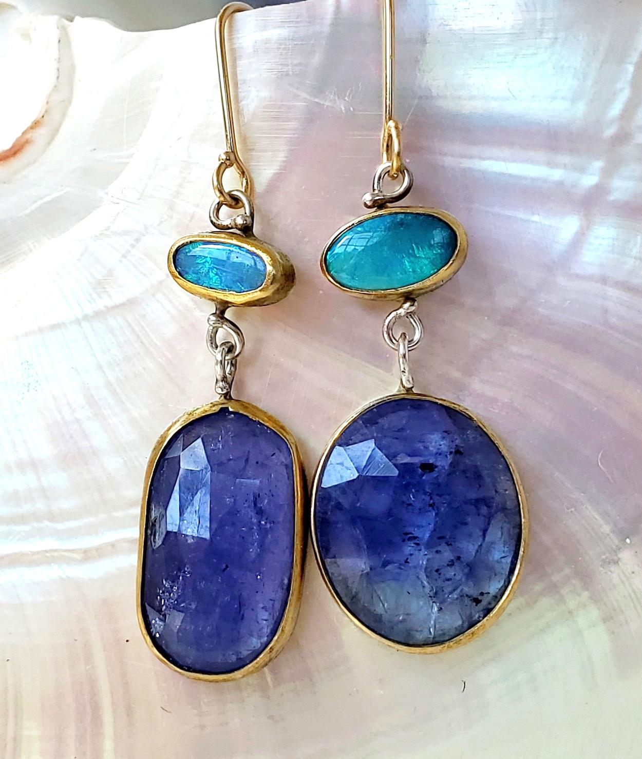 Mis matched Lightning Ridge opal earrings with rose cut tanzanite drops. Subtly distinct and different to make it interesting! All the gems are handset in 22K gold bezels and sterling silver backs (cut out on the back of the tanzanites to let the