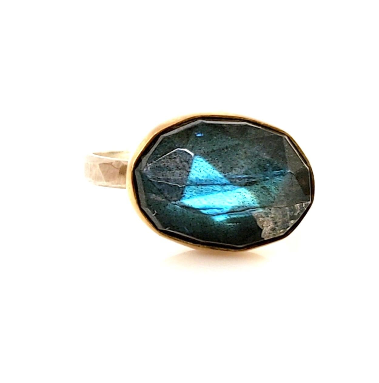 Rose cut labradorite stone, just over 7.75 carats, about 10 x 14 mm, hand set in a 22K gold bezel, sterling silver back and band. Hammered band with a brush finish. Size 7. This stone has been cut with a nice high dome (about 6.5 mm high) and