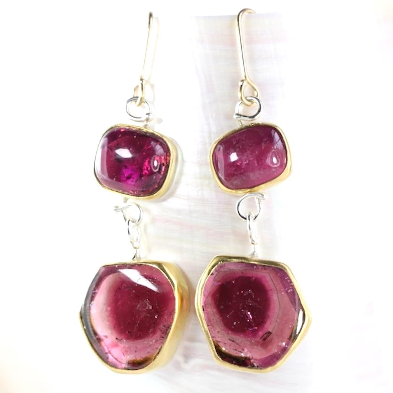 Rubelite earrings with deep pink on pink watermelon tourmaline drops. Rubelite cabochon and watermelon tourmaline slices, all handset in 22K gold bezels with sterling silver cut out backs, sterling silver wirework. Handmade 18K gold earwires.