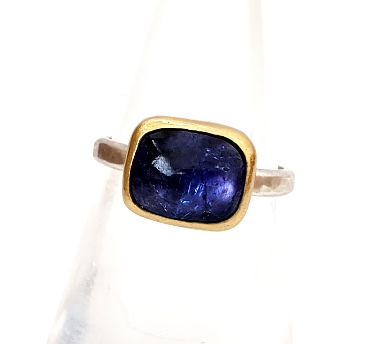 Purple/blue tanzanite square cabochon ring. This gemstone is handset in a 22K gold bezel, sterling silver back and band. Hammered band with a brush finish. Versatile, suitable for stacking. Size 7.25. Tanzanite cab: 4.1 carats

The Metaphysical