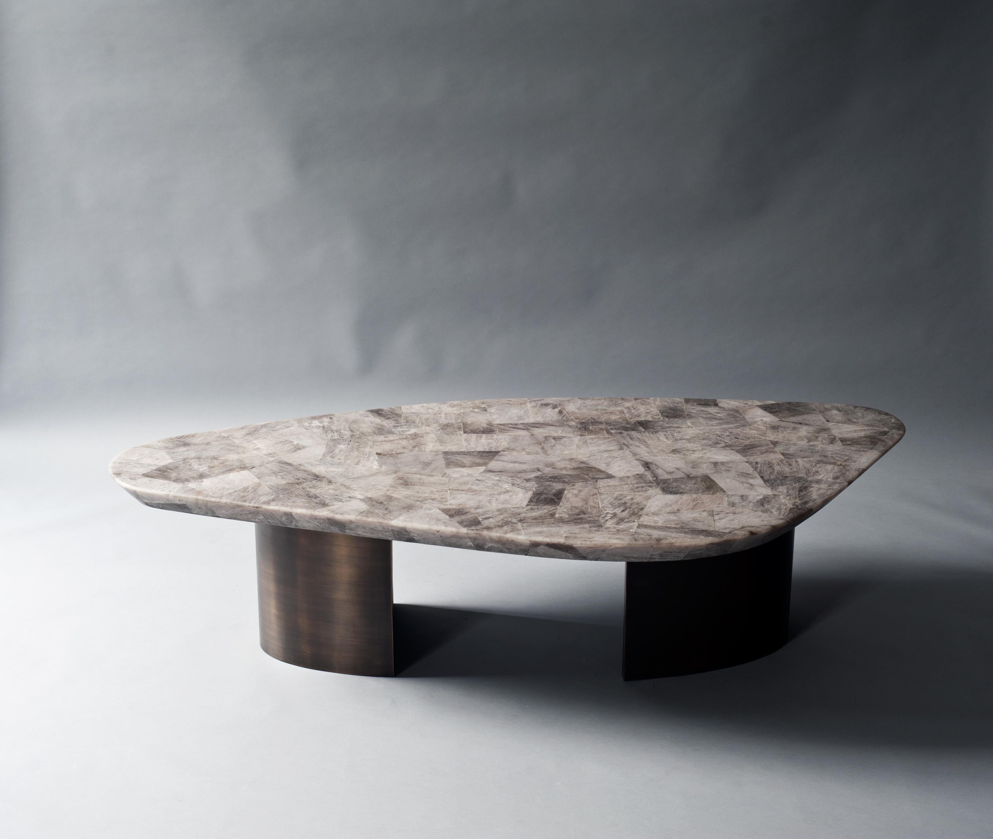 Ledge coffee table by DeMuro Das 
Dimensions: W 162.2 x D 80.7 x H 39.4 cm
Materials: Quartz (Smokey) - Leather (Random)
 Solid brass (Antique)

Dimensions and finishes can be customized

DeMuro Das is an international design firm and the