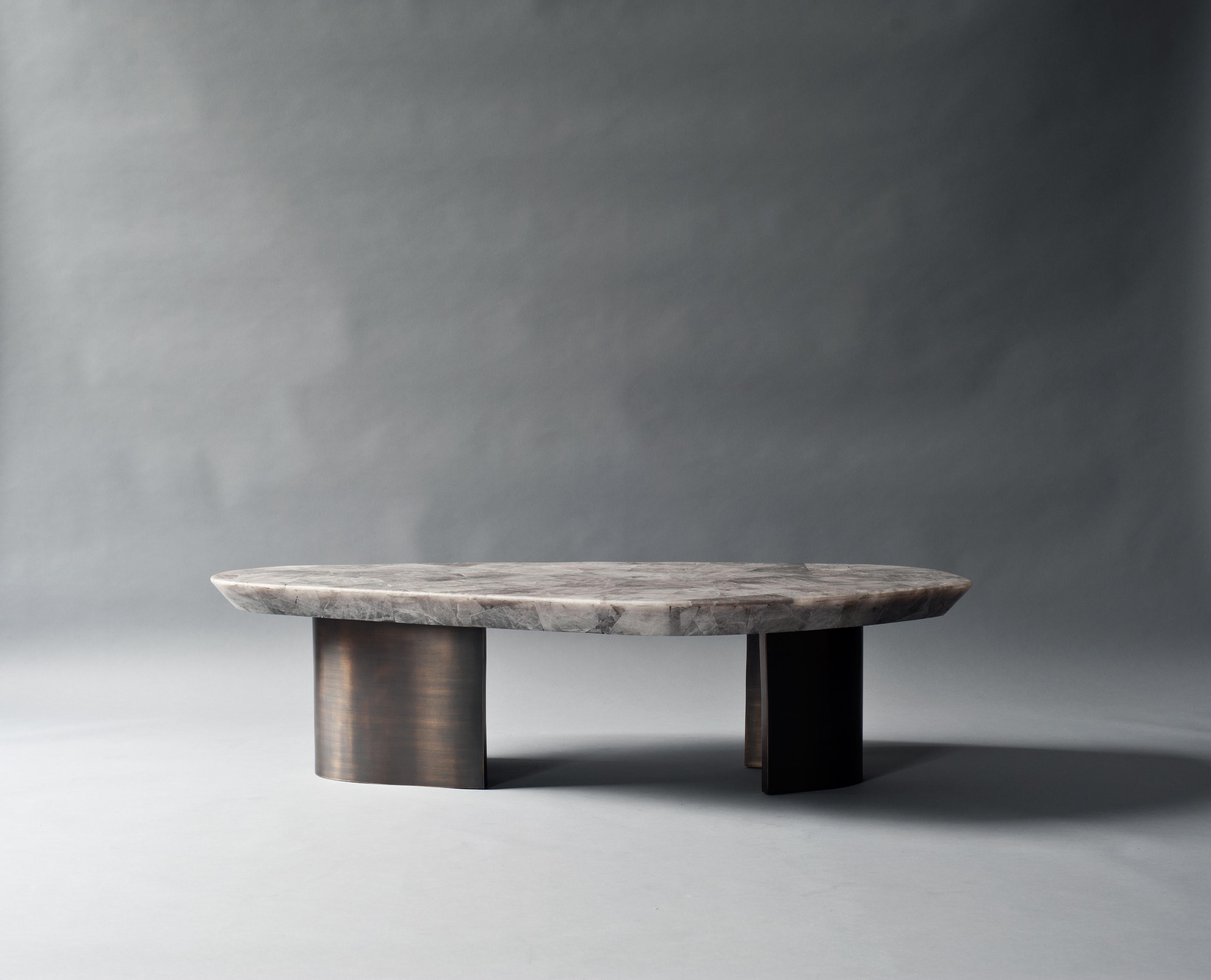 Ledge coffee table by DeMuro Das 
Dimensions: W 68 x D 126.6 x H 32.9 cm
Materials: Quartz (Smokey) - Leather (Random)
 Solid brass (Antique)

Dimensions and finishes can be customized 

DeMuro Das is an international design firm and the