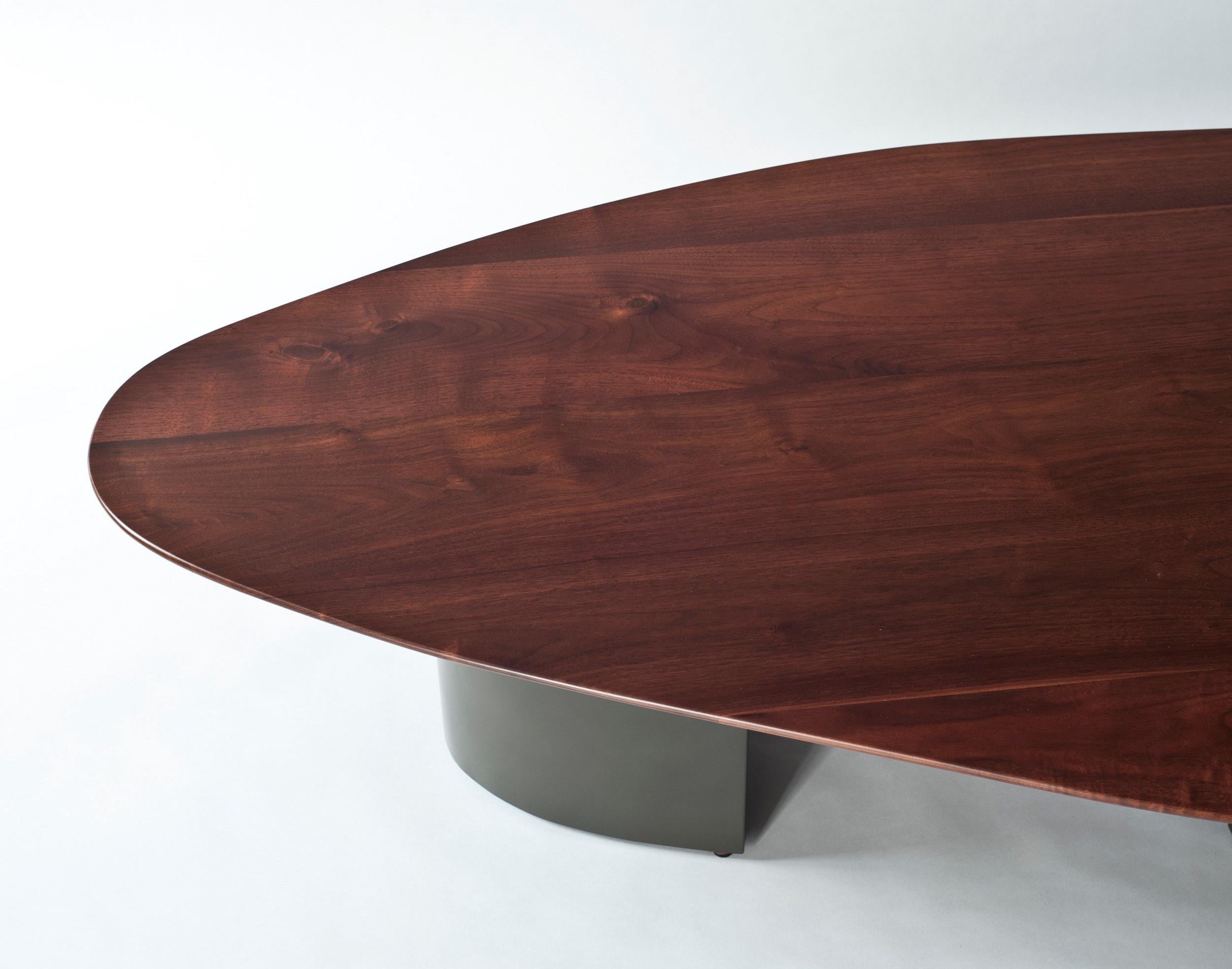 Sculptural solid walnut top with base in olive grey lacquer.