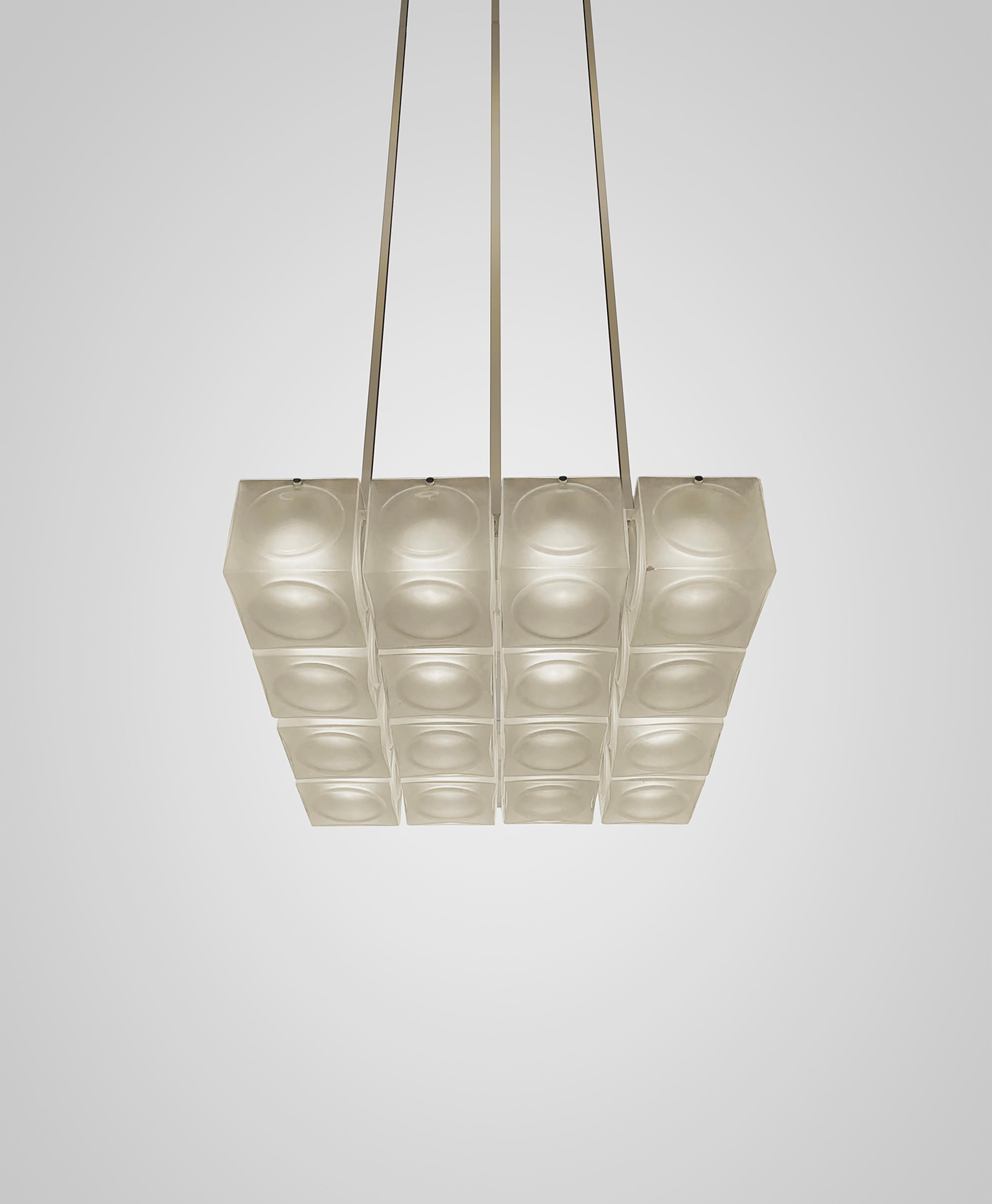 Inspired by the pressed glass bricks often used as an alternative to stained glass in places of worship during the 1970s, Chant is formed of blown glass cubes with a pronounced circular detail in either clear or frosted glass. 

Constructed in