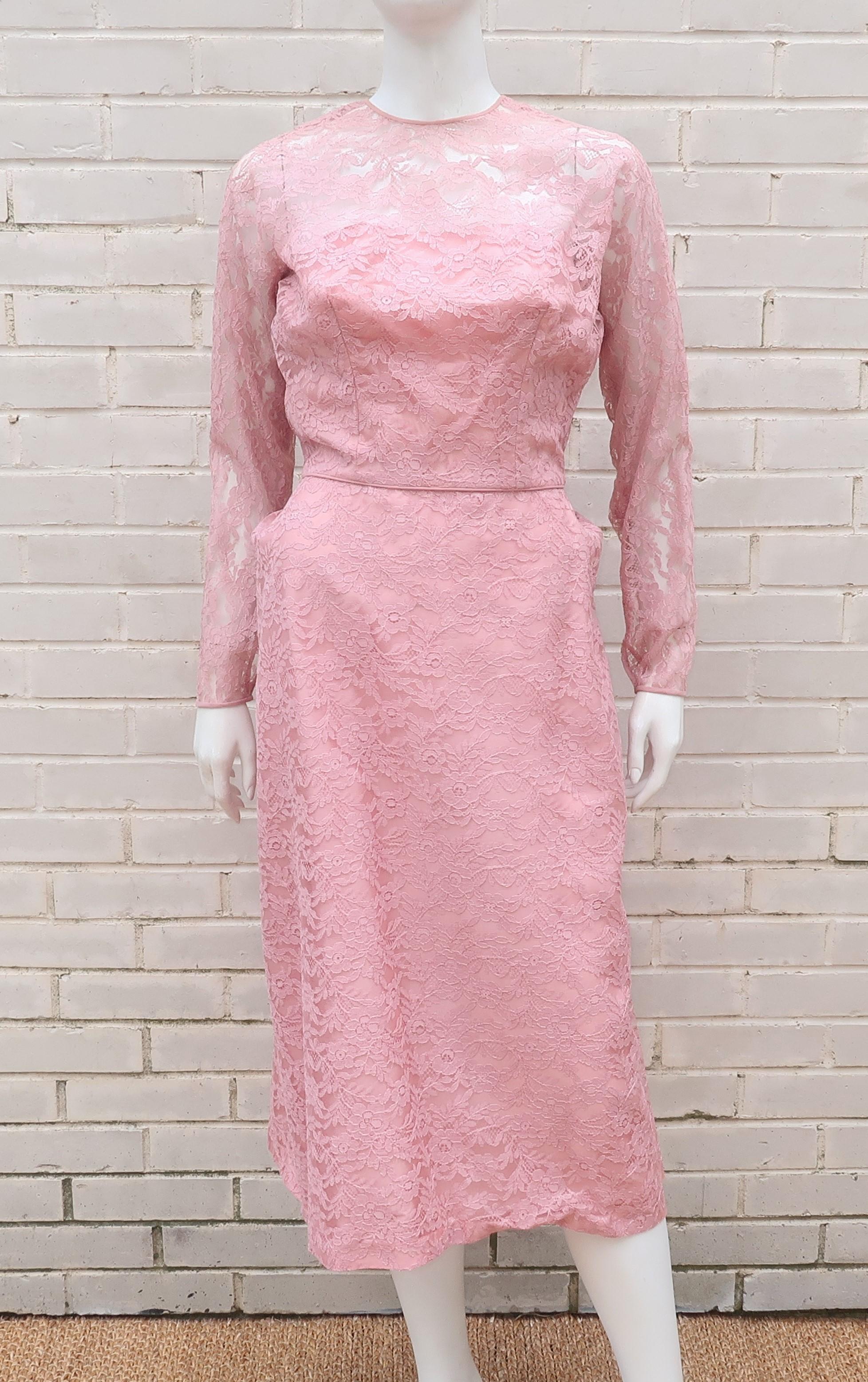 A lovely 1950's cocktail dress from Lee Claire New York in a mauve pink lace with a unique modified bustle style silhouette.  The dress zips and hooks at the back with a button at the neckline and snaps at the cuffs.  The modified bustle is