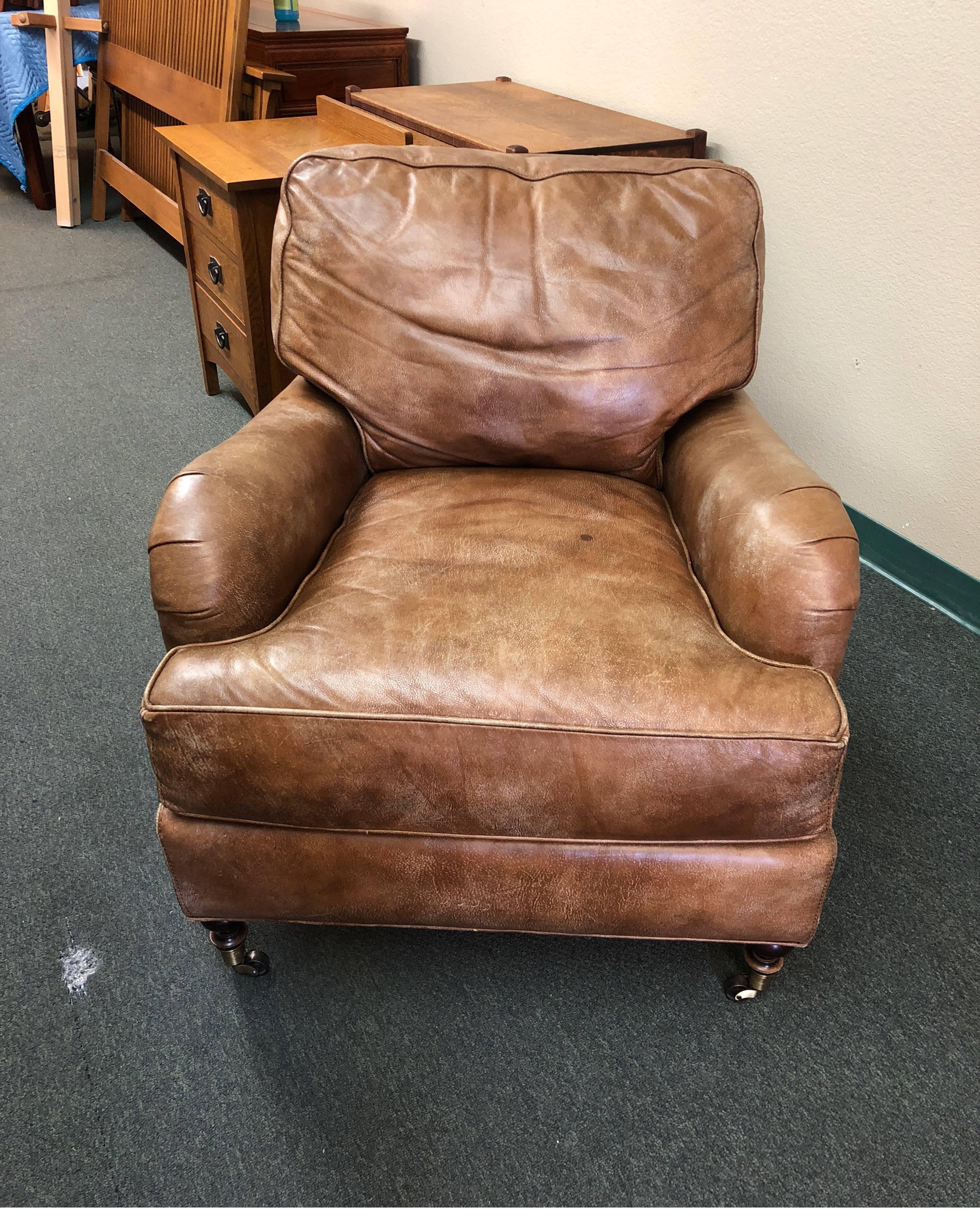 Well made armchair by Lee Industries, this worn-look leather armchair will become a favorite. Loose cushions, self welting and brass casters. Upholstered in Cambridge leather. Measures: Arm height 24 inches., seat height 19 inches.

 