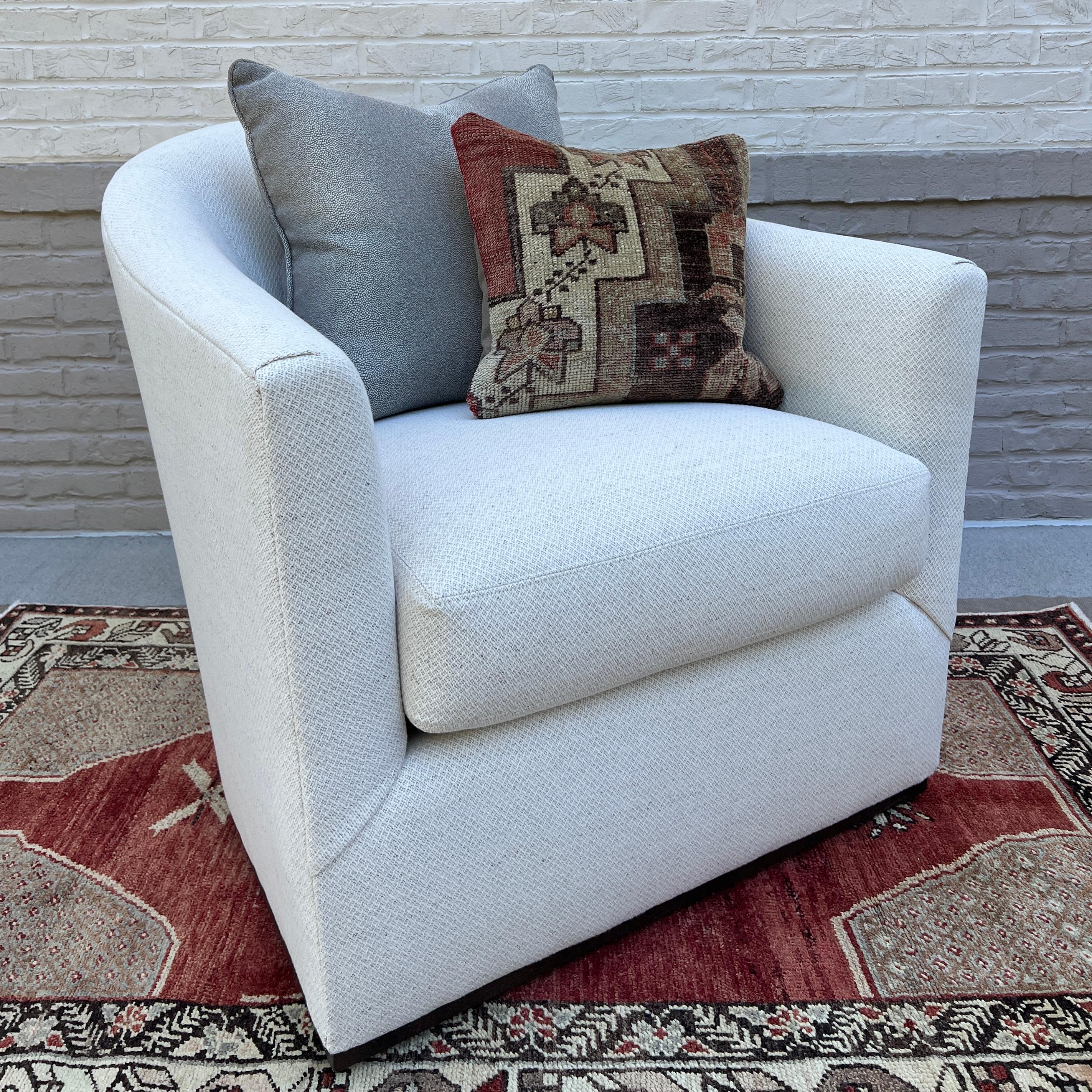 Custom made LEE Industries, Inc. 5702-01 Swivel Chair (2 available). These chairs are showroom new and have never been used.

This chair has a softly curved back and is trimmed with a small line of wood around its base. Wales Natural fabric is a