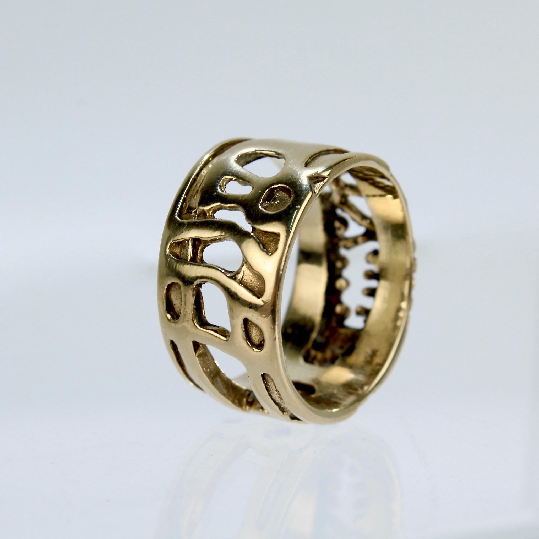 A fine Lee Peck band ring with openwork. 

Lee Barnes Peck was a distinguished Professor of Metal and Jewelry at Northern Illinois for decades. His work is held in important public and private collections.  

Stamped 14K and PECK to the shank. 

