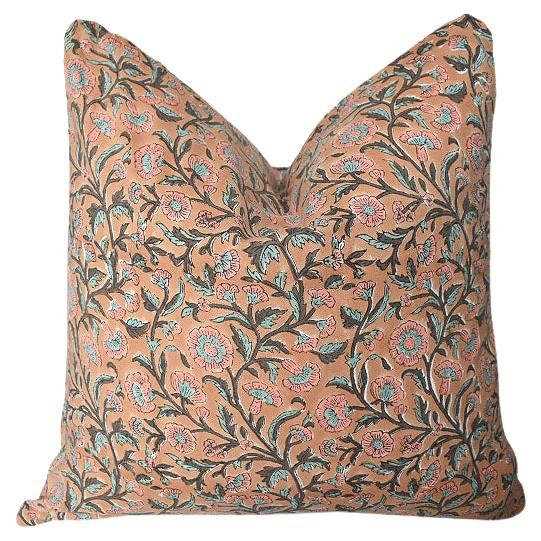 Bring a taste of the orient to any space with one of our custom-created Indian block print pillows. Each pillow is made of soft cotton and hand block printed by our artisans in India. Set on a salmon pink background, poppy flowers in blue and black
