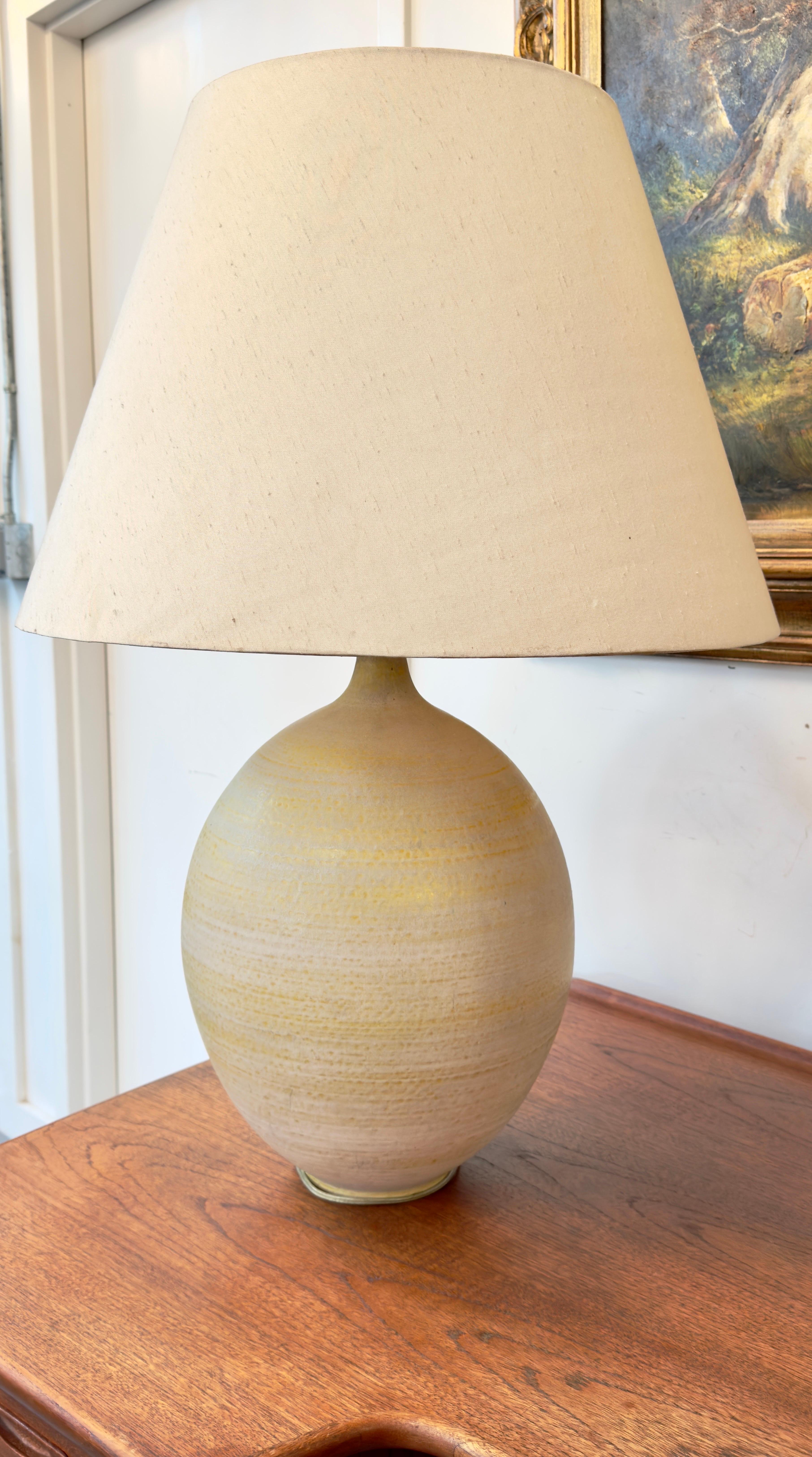 An exquisite Mid Century Modern oversized ceramic table lamp designed by Lee Rosen for Design Technics, N.Y. Distinguished by its generous proportions, this lamp boasts a captivating array of neutral hues, intricately layered to evoke a sense of