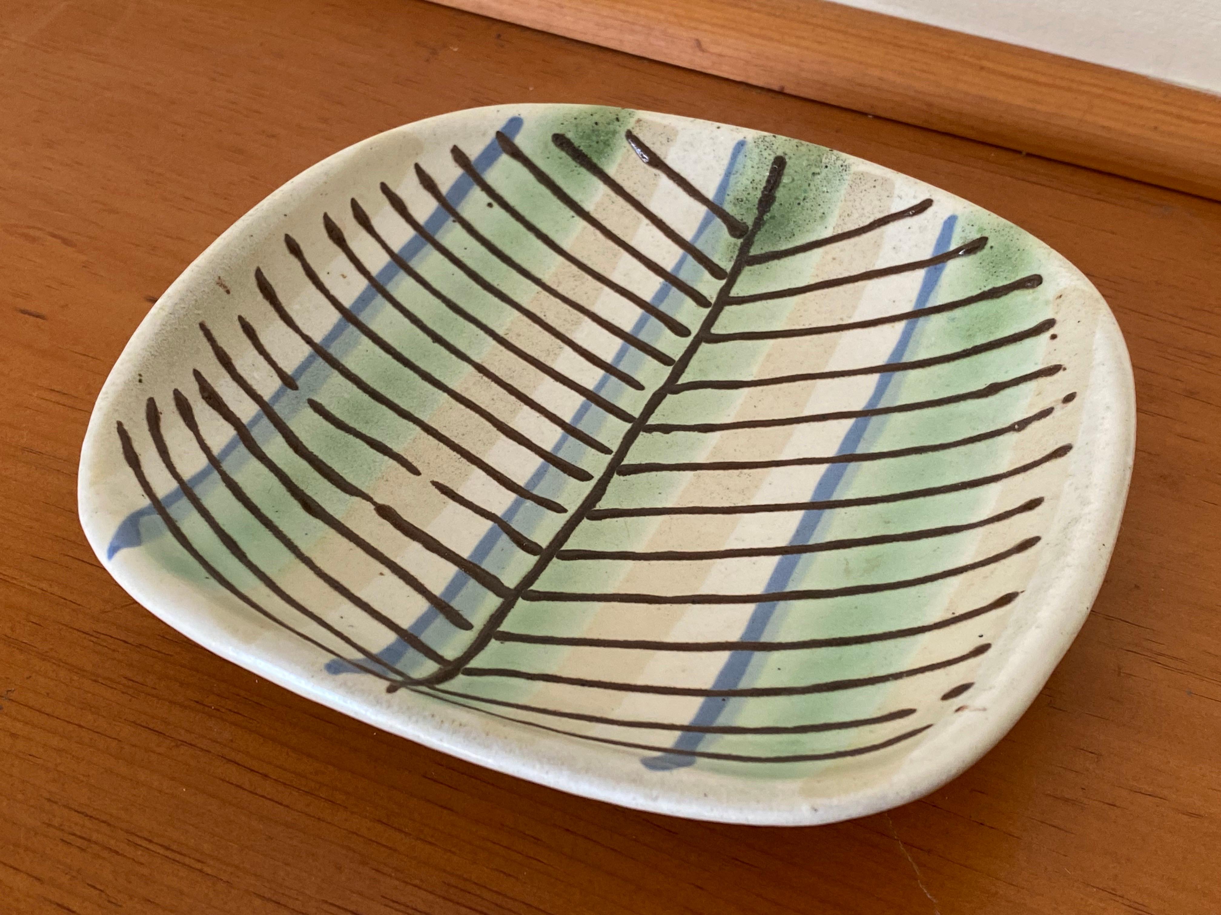 Un piatto in ceramica dipinto e decorato a mano alla fine degli anni '40 da Lee Rosen per Design/One. Questo piatto presenta la tecnica delle 