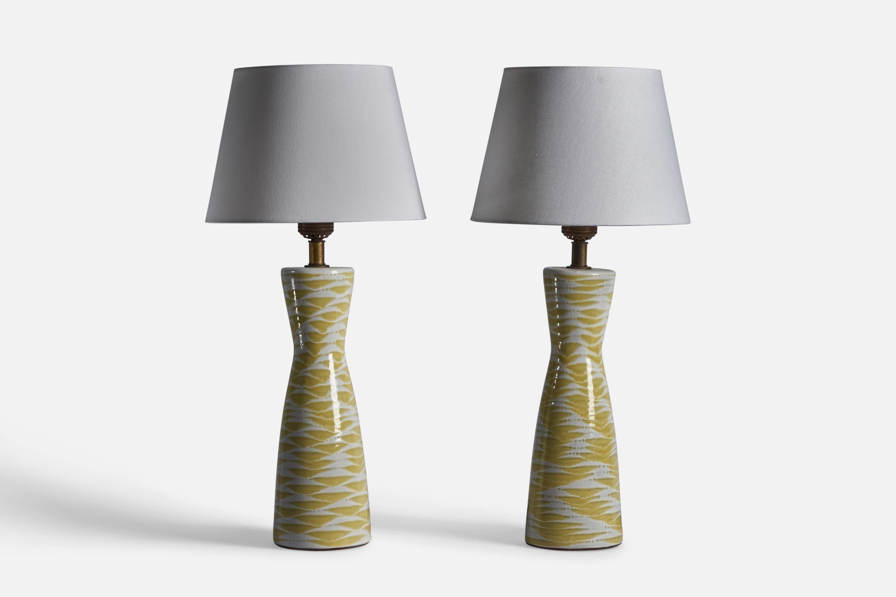 A pair of large yellow-glazed ceramic and brass table lamps, designed by Lee Rosen and produced by DESIGN-TECHNICS, USA, c. 1950s.

Dimensions of Lamp (inches): 30