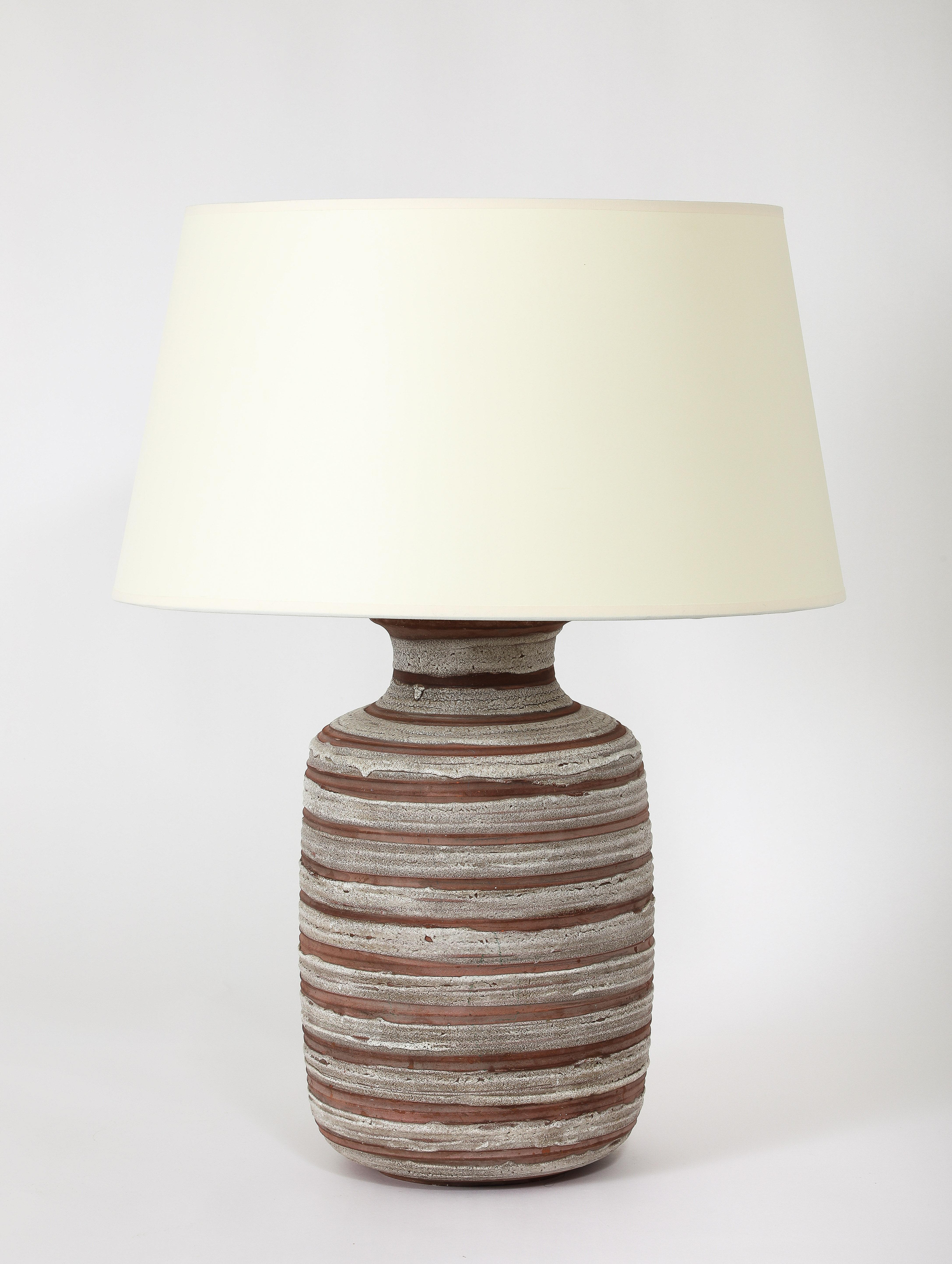 Minimalist table lamp with a large body matte white glaze over raw terra-cotta.