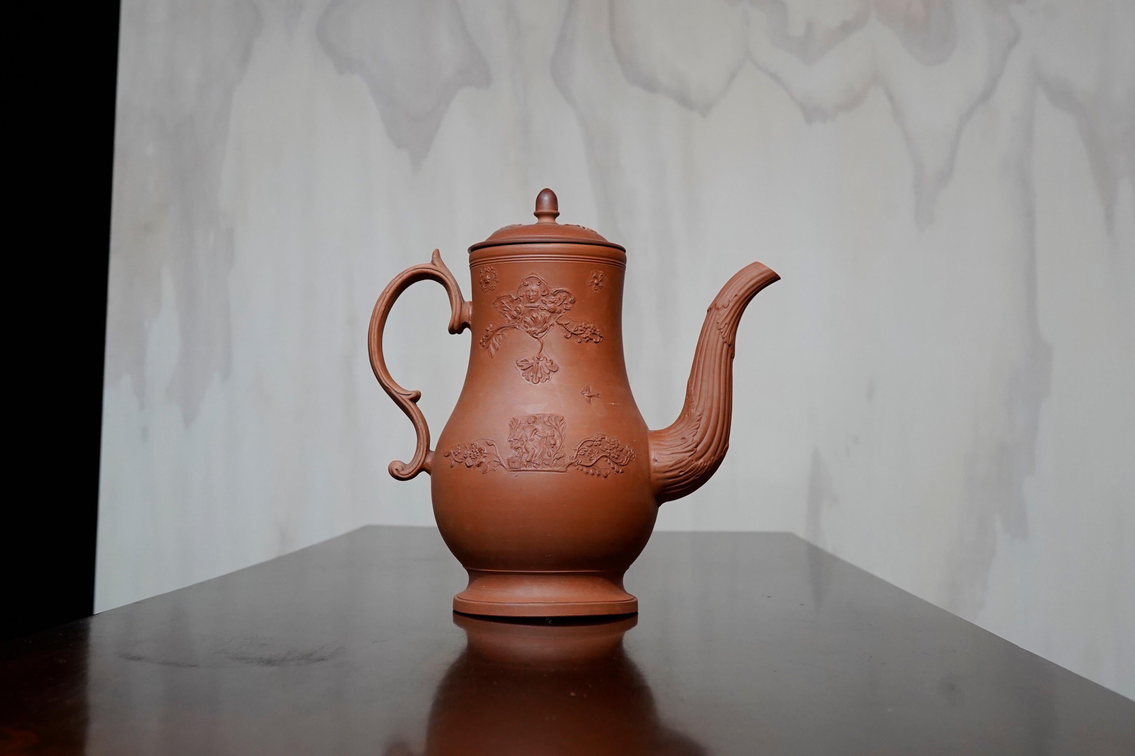 Redware coffee pot, with Rococo sprigging including a ‘man-in-the-moon’, acanthus leaf moulded spout, and distinct Rococo handle with basketweave.

Unmarked, attributed to Leeds,

circa 1765

The features of this vessel give clues to its