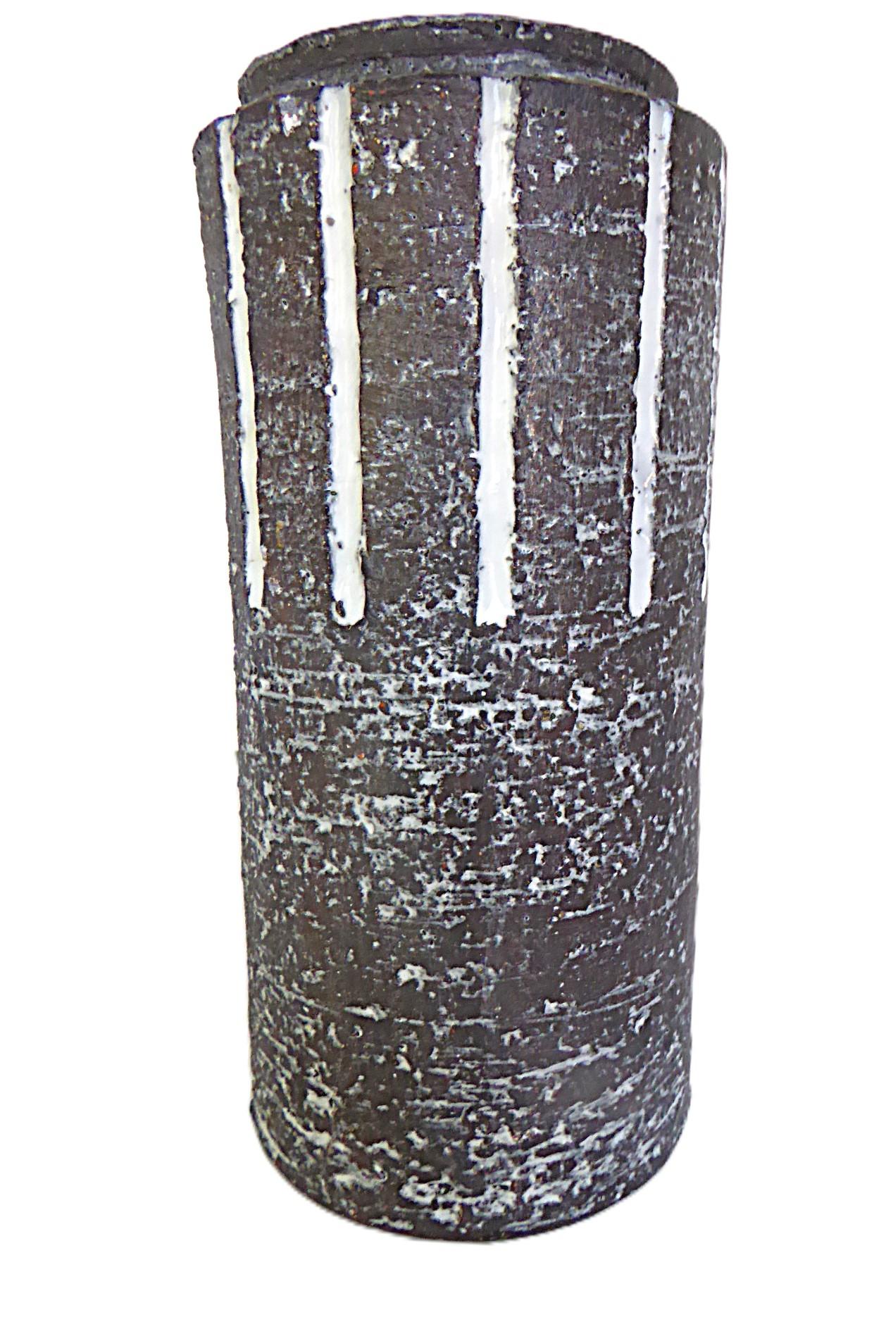 Dutch ceramist Leendert Blok created this Chanoir cylindrical pottery vase for Westraven Pottery in Utrecht, The Netherlands in the late 1950s. With a textured brown body and smooth white glaze inside, is an Organic Modern beauty. A carved design of