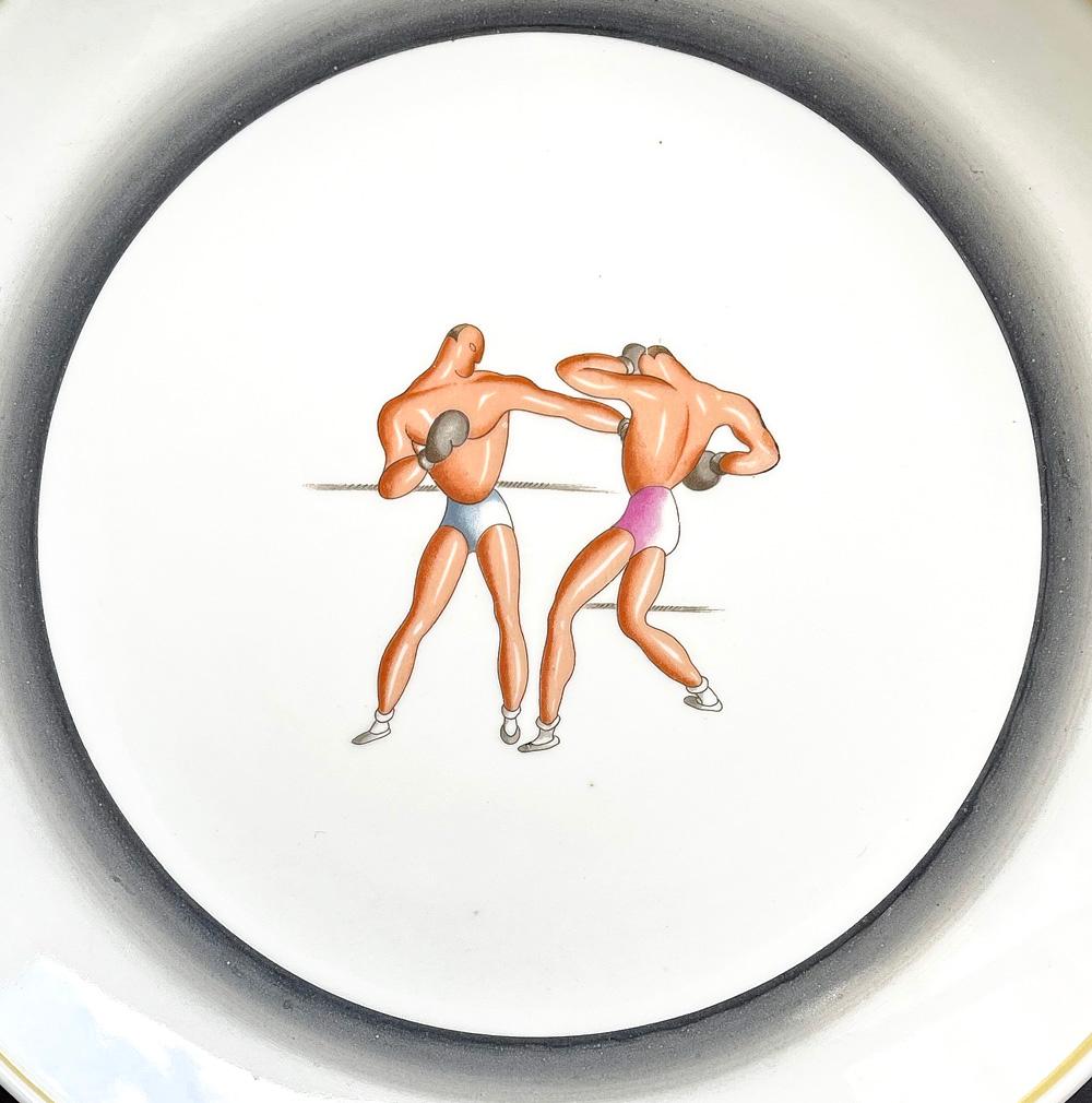 Rare and striking, this compote or footed bowl depicts two streamlined, glowing boxers, one throwing a left jab toward the other who protects his face from the oncoming blow. This piece was designed by the renowned Italian designer and architect,