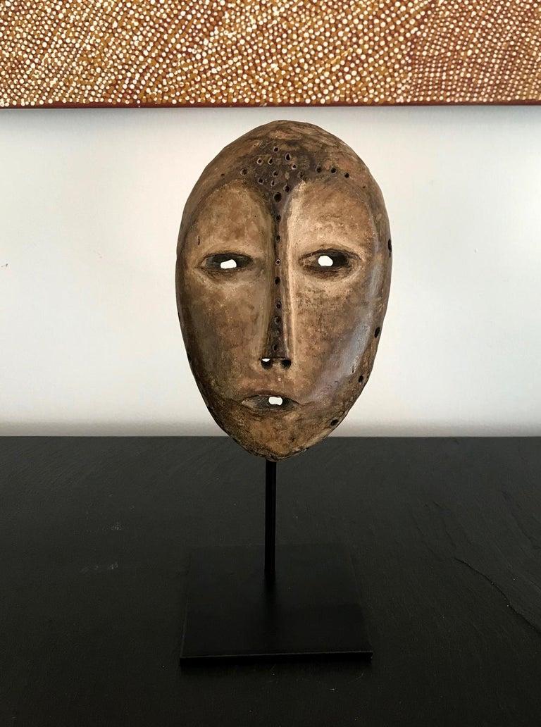 Se ofrece una máscara de madera de la sociedad Lega Bwami de la República Democrática del Congo. Era probablemente de la primera mitad del siglo XX y una auténtica pieza de campo. La máscara presenta una bonita pátina tanto en el anverso como en el