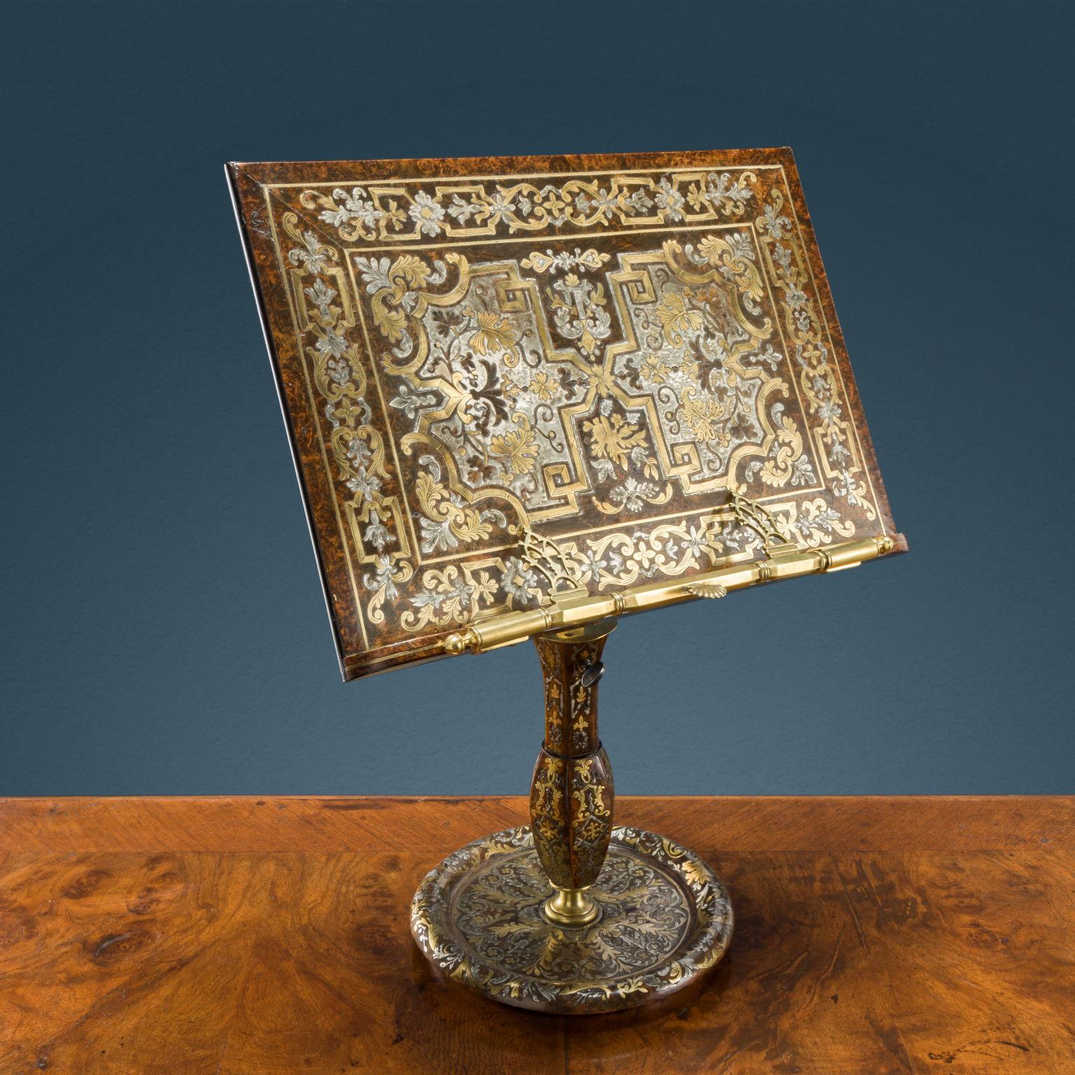 Table lectern resting on a circular base and supported by a central stem, into which the height-adjustment rod engages, with mechanical device for tilting the brass lectern with blued steel parts, as well as the score stop on the front. The work is