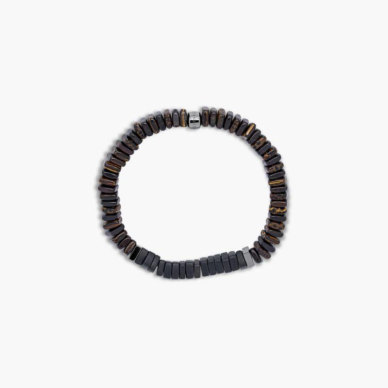 Legno Bracelet in Black Onyx, Palm and Ebony Wood with Black Rhodium Plated Sterling Silver, Size L

Ebony and palm wood beads are accented by hand-polished, black rhodium plated sterling silver discs with onyx stones sitting in the centre for a