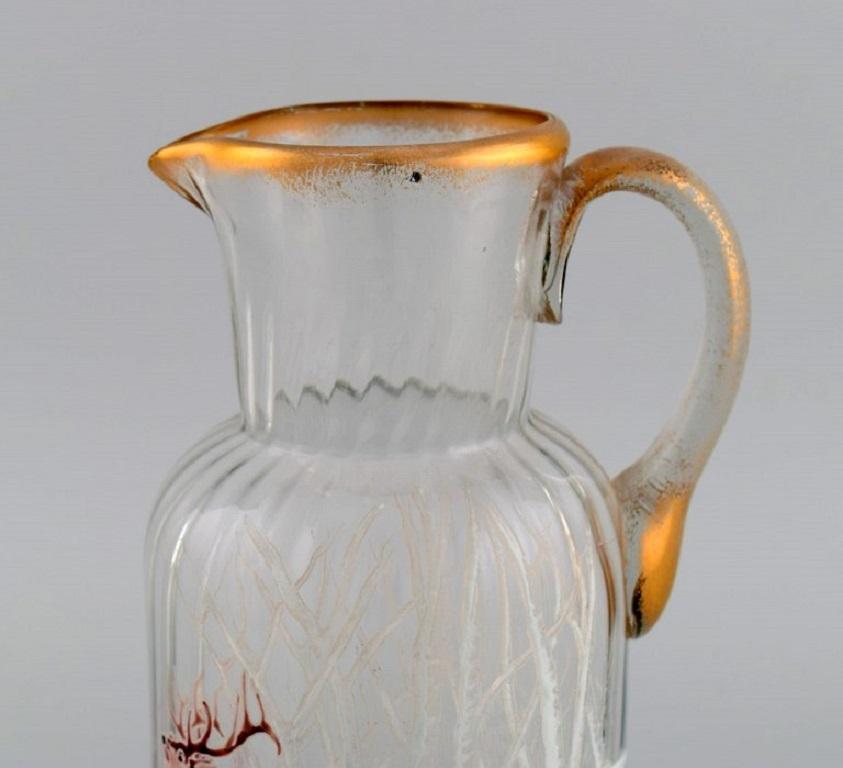 Legras Saint Denis. Russian beer jug in mouth blown art glass with hand-painted red deer in winter landscape. France, ca. 1900.
Measures: 25 x 17 cm.
In excellent condition.