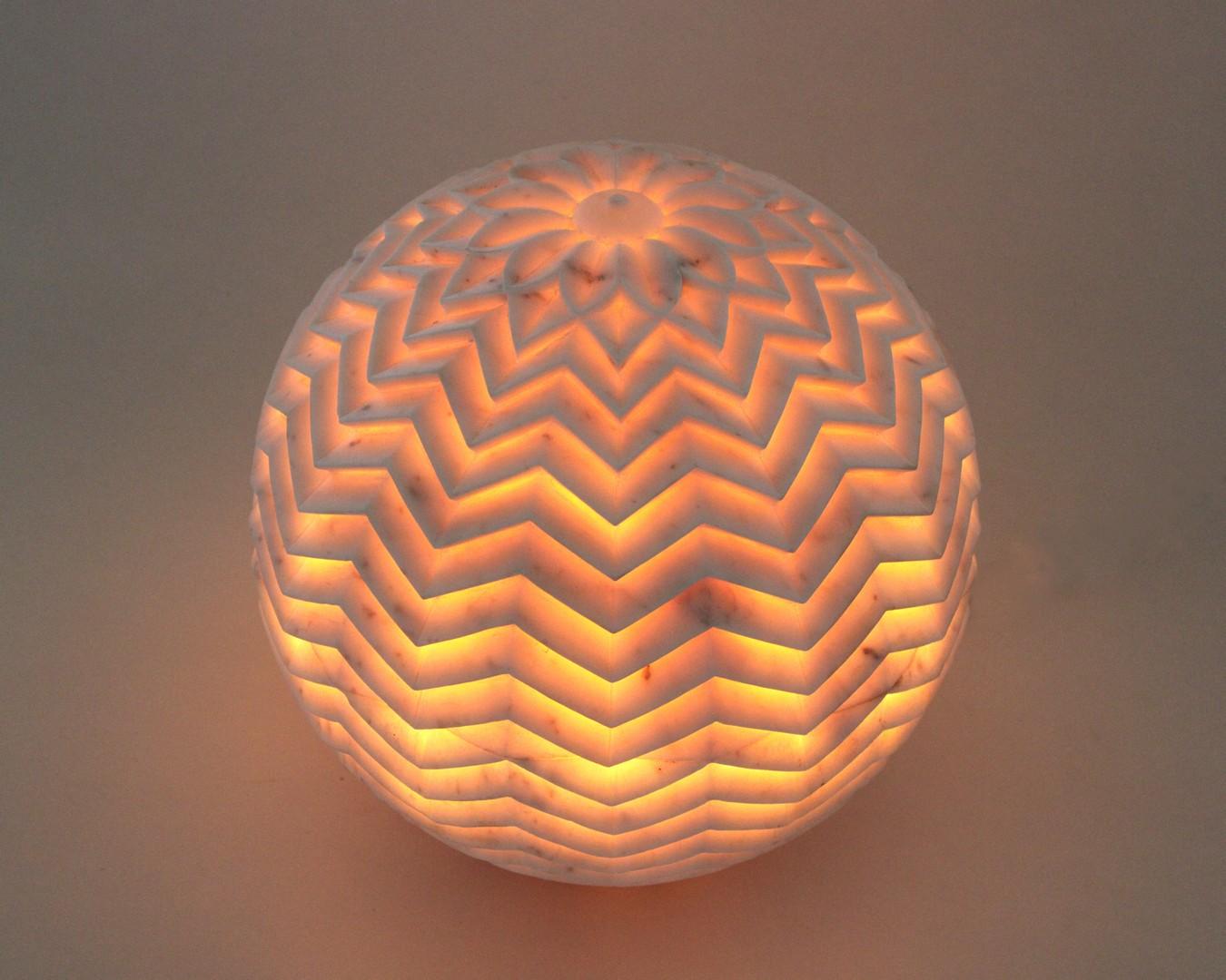 Inspired by the leheriya (similar to chevron) pattern she observed in her travels in rural Rajasthan, Stephanie Odegard designed this beautiful floor/outdoor lighting fixture. Solid pieces of marble are first turned into hemispherical halves and