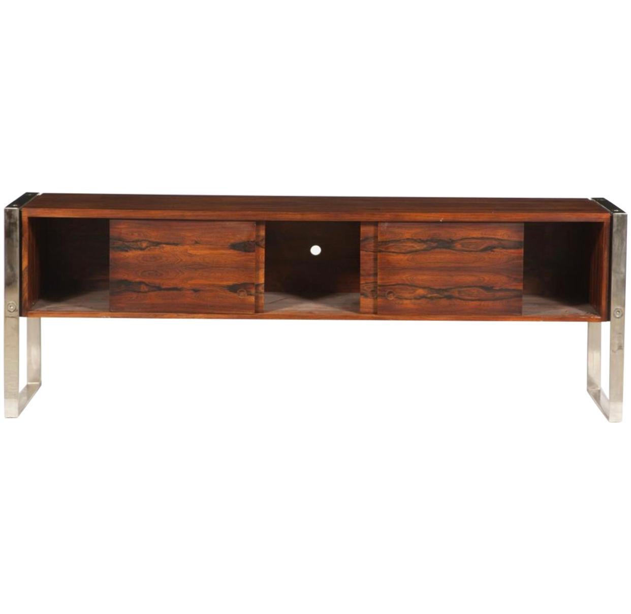 Spectacular credenza by Leif Jacobsen executed in rosewood and chromed metal circa 1960s. Rectangular cabinet with four sliding doors. Holes in back of cabinet for electronic component wiring. Measures: Height 28 1/2 inches, length 7 feet, depth 20