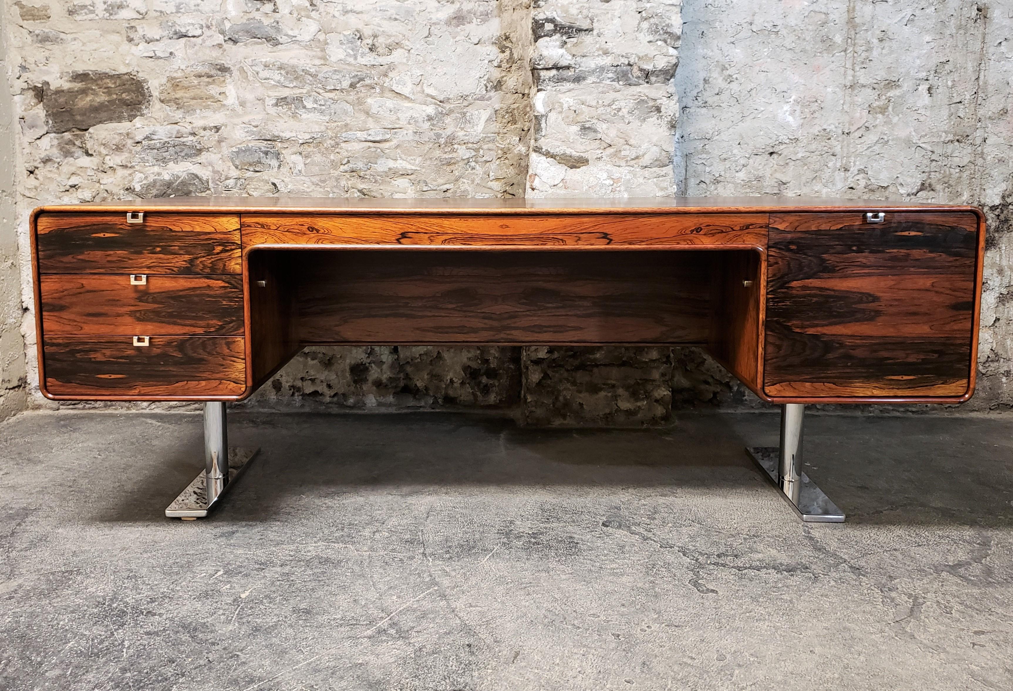 Rare Mid-Century Modern Leif Jacobsen executive desk, circa 1970. This high quality constructed desk features beautiful exotic rosewood grain, a finished back, spacious drawers, chrome hardware and cantilevered legs.