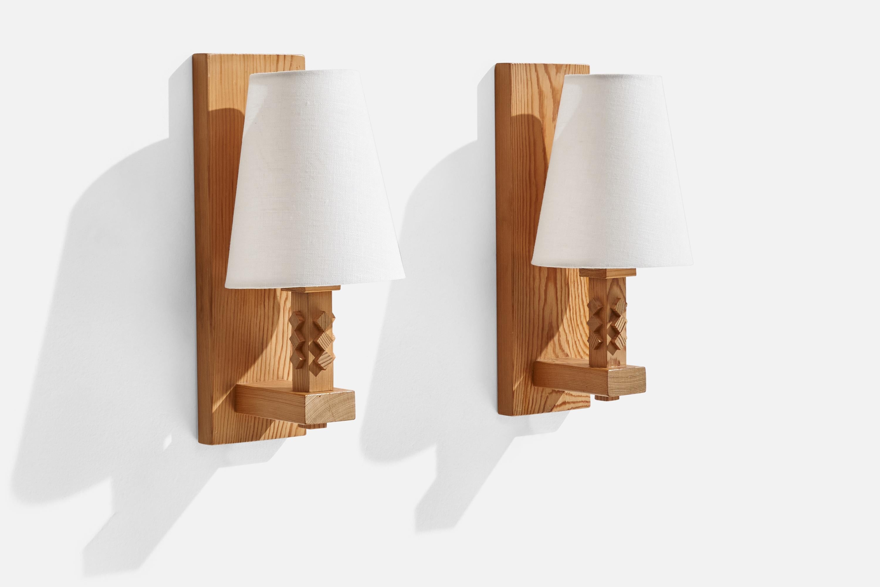 A pair of pine wall lights designed and produced by Leif Wikner, Persåsen, Kövra, Sweden, c. 1970s.

Overall Dimensions (inches): 11.25” H x 5” W x 5.38” D

Back Plate Dimensions (inches):N/A

Bulb Specifications: E-26 Bulb

Number of Sockets:
