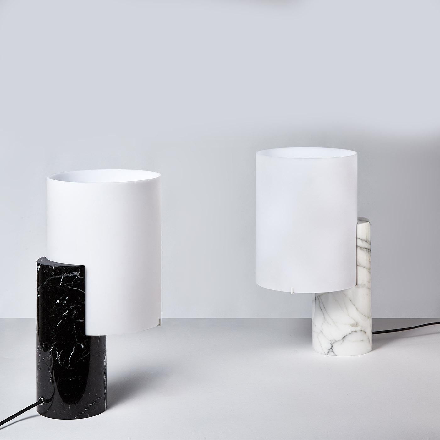 This gorgeous table lamp celebrates simplicity and quality. Handmade of first-rate materials rendered in clean shapes, it features a black Marquina marble body, and a satin white shade made of polycarbonate. Designed by Matteo Nunziati, it supports