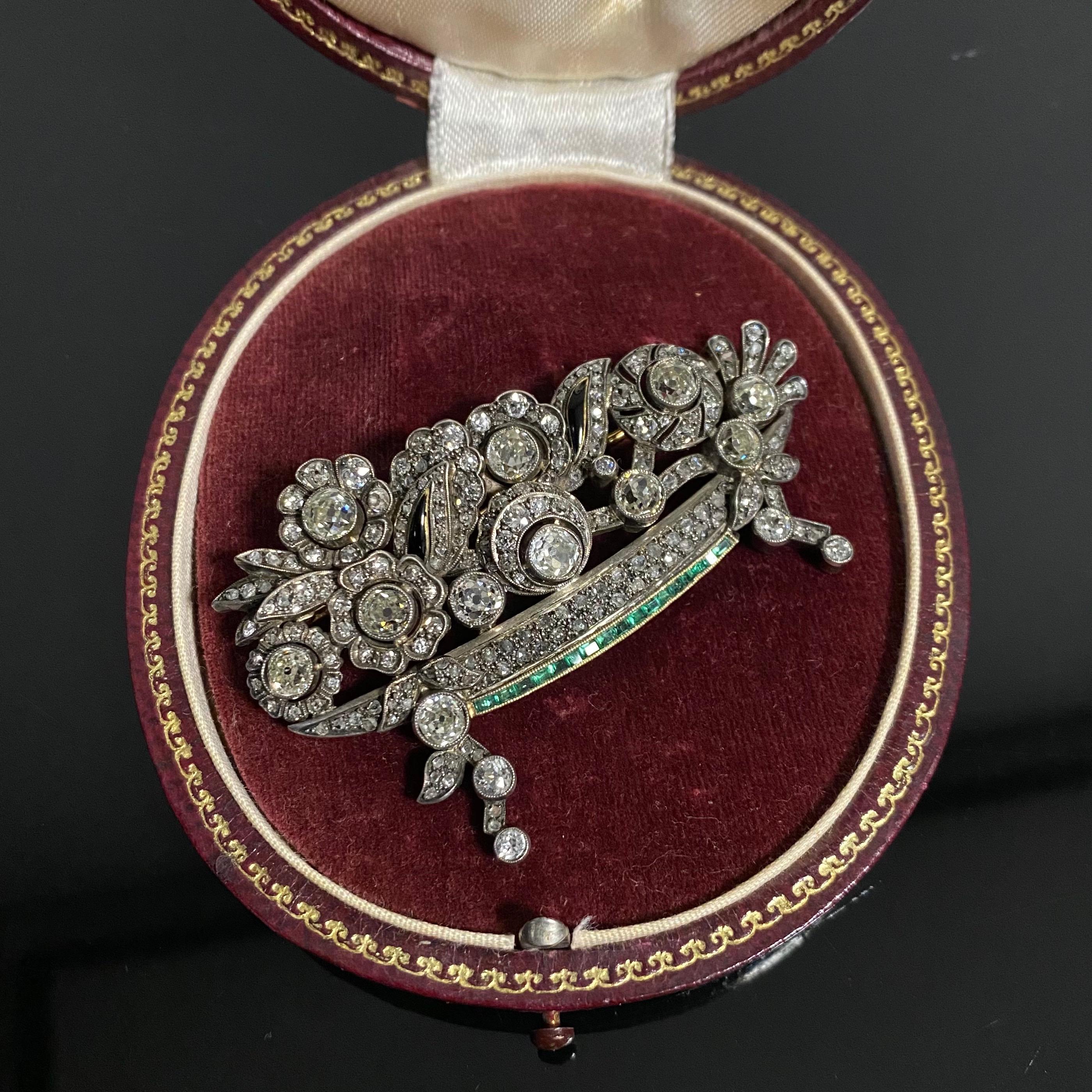 Art Deco Leitão & Irmão Diamond, Emerald and Enamel Giardinetto Floral Brooch in Silver and Gold, Portugal, c. 1940, in original case, with a total gem weight of approximately 7.84ct. Designed as a stylized openwork giardinetto, the flowers grain-