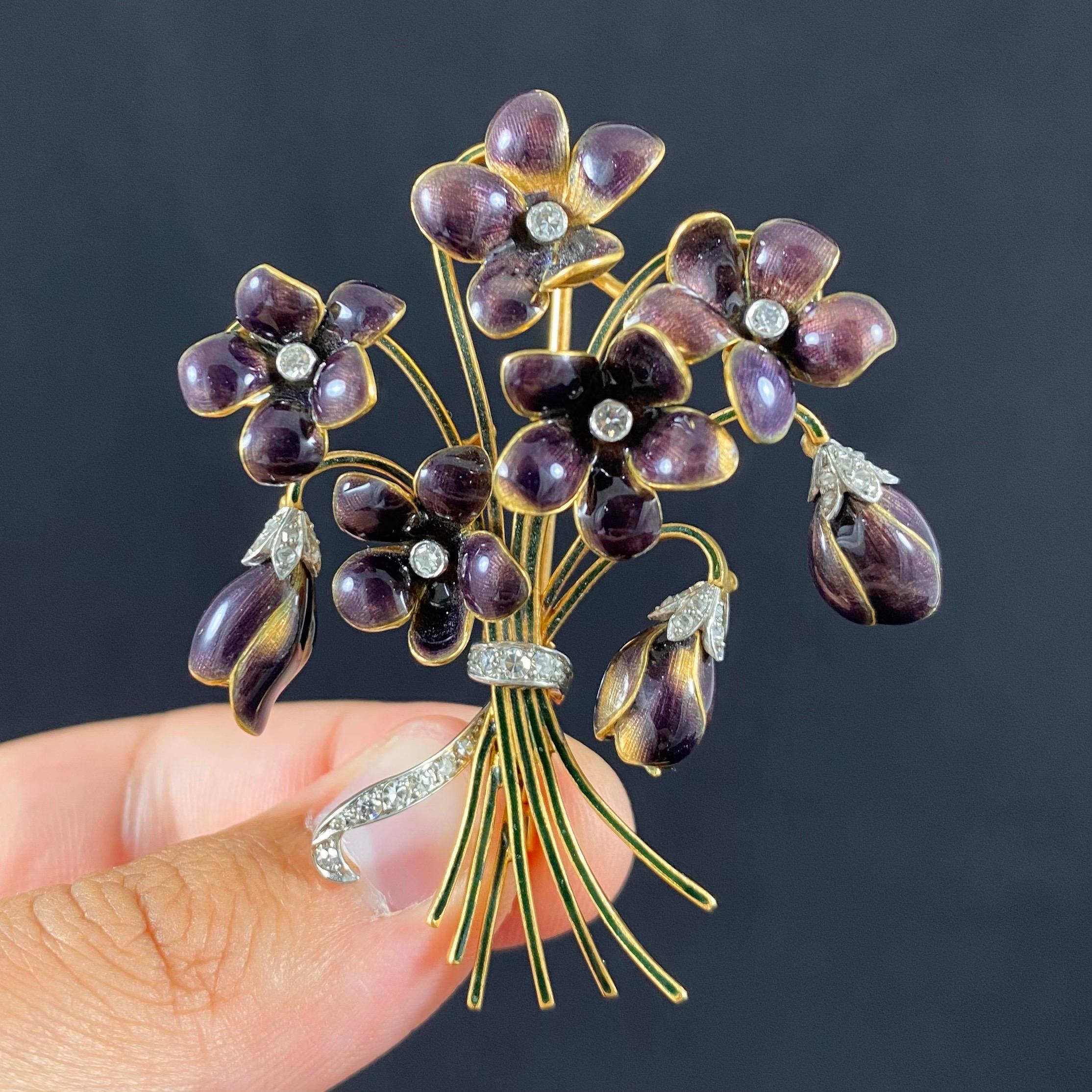Retro diamond and polychrome enamel violet floral bouquet brooch in 19.2kt yellow gold and platinum, by Portuguese crown jeweler Leitão & Irmão, 1940s, accompanied by the maker’s case. This brooch is modelled as a bouquet of eight violets, each