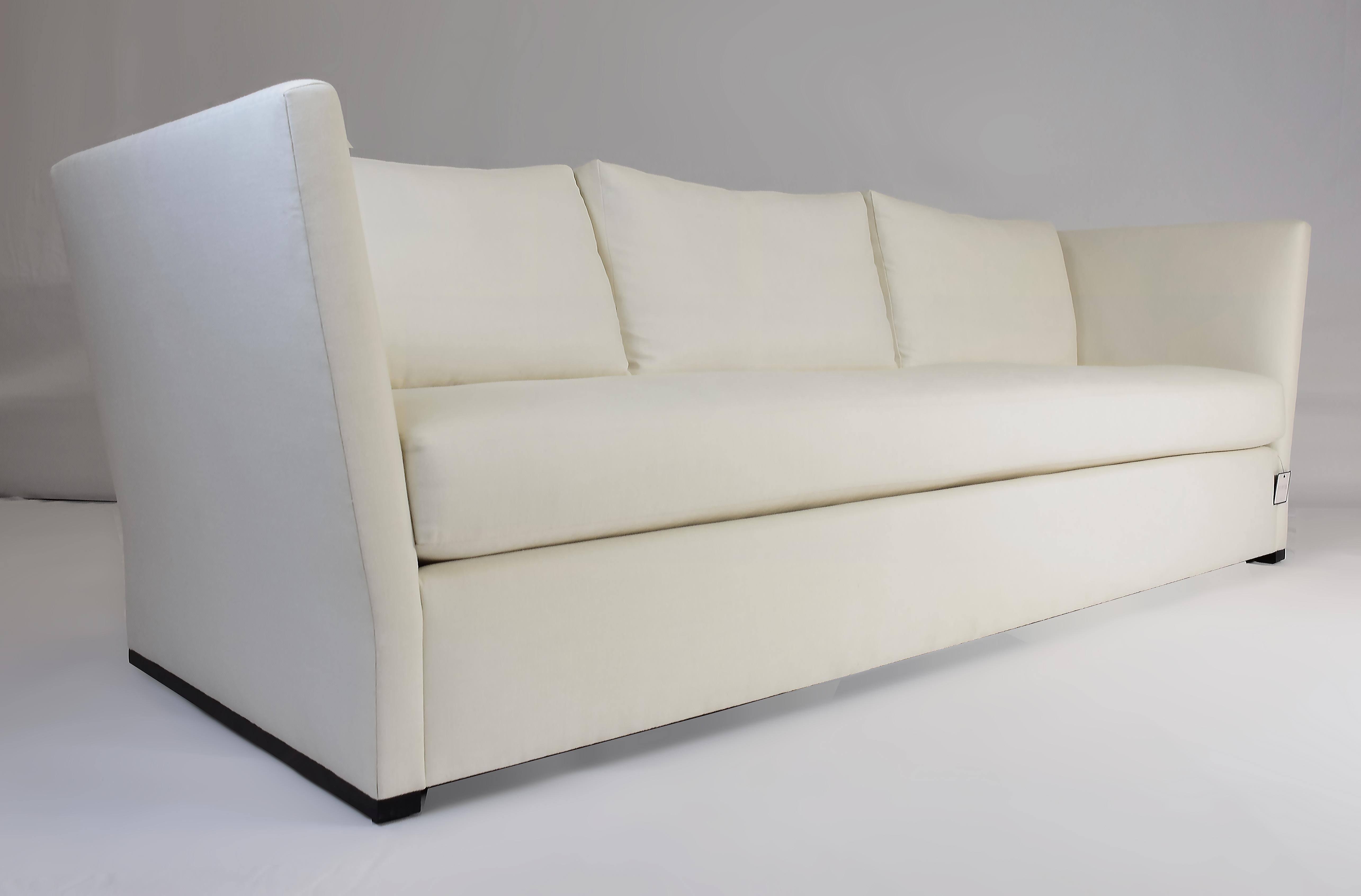 Le Jeune Upholstery Jones Angled Arm Sofa Showroom Model

Offered for sale is a truly classic styled Sofa with outward angled arms to simulate their being on a hinge, however,  they are fixed. The long bench seat cushion is made with an