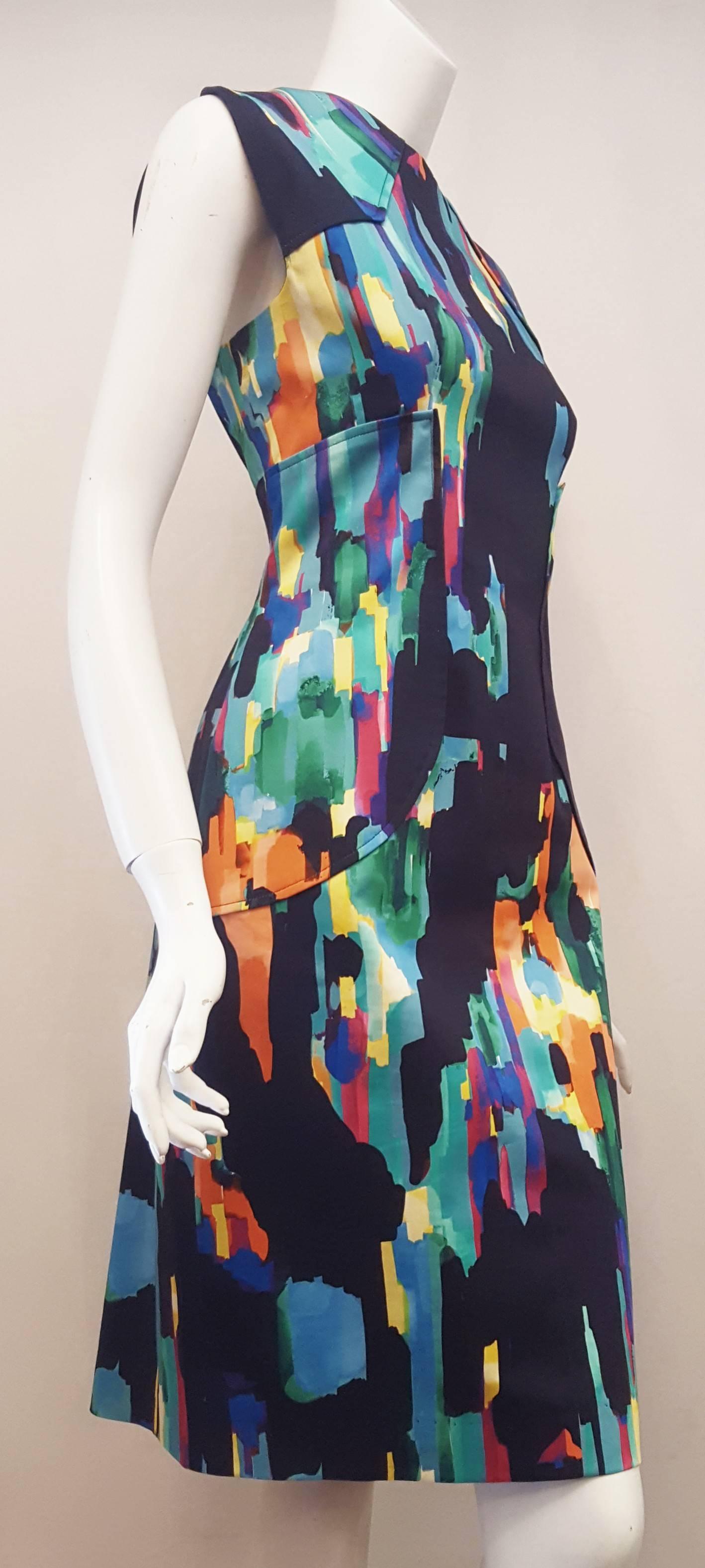 This Lela Rose primary colors dress with black base with side panels at the waist and round neckline can be accessorized with many colored handbags and shoes.  For closure a long zipper at back.  For comfort in walking a small vent, also, at back. 