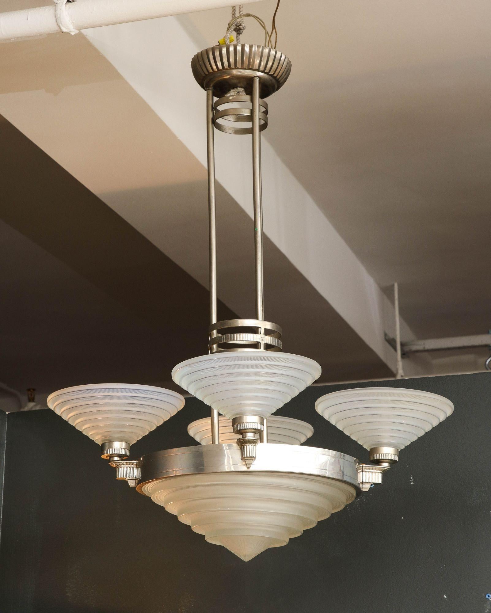 Georges Leleu French Art Deco five-light chandelier, originating from France in the early 20th century. This striking piece showcases a modernist form with a nickel-plated metal frame, highlighting the Art Deco design. The chandelier features a
